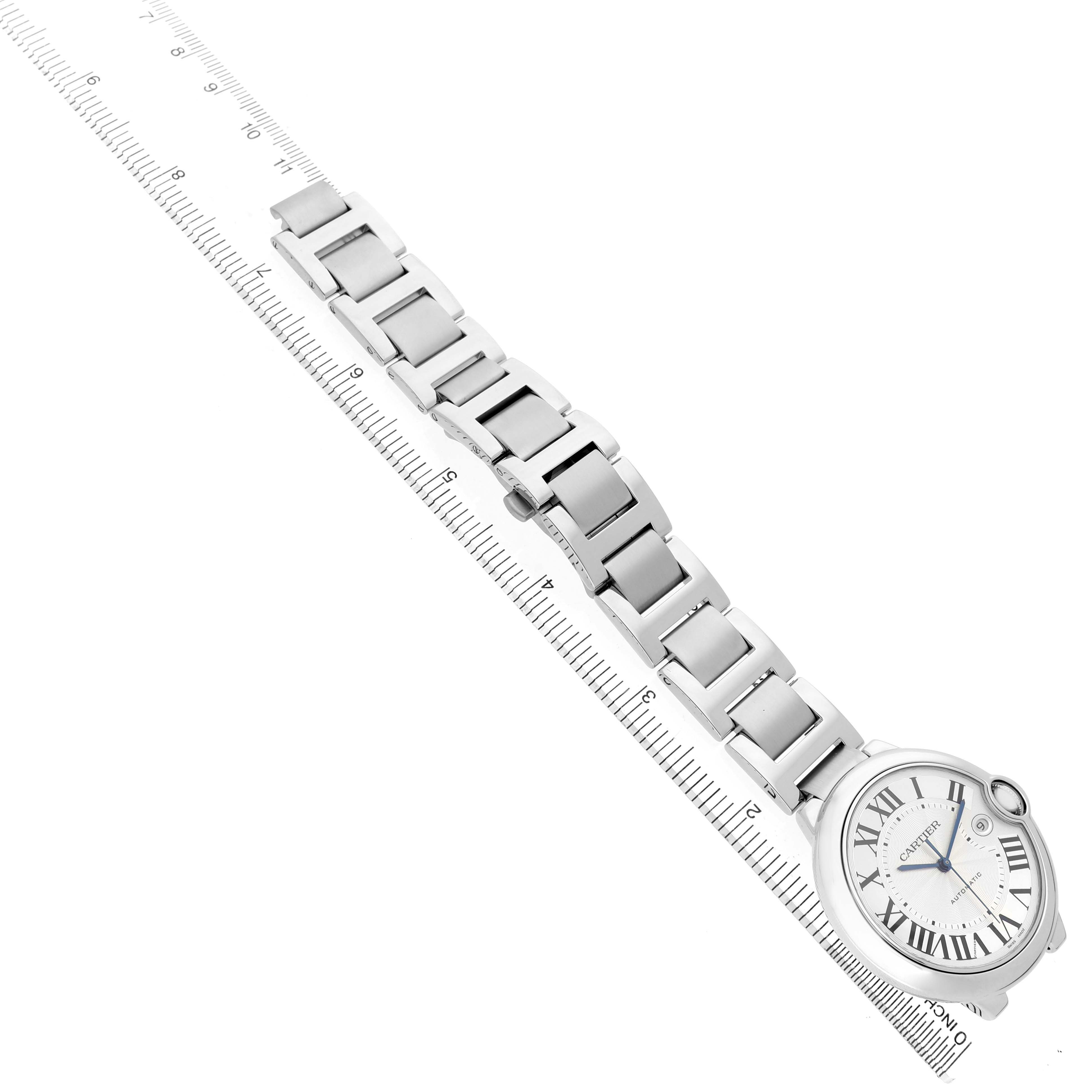 The image shows a Cartier Ballon Bleu W69012Z4 Men's Stainless Steel Silver Dial watch laid flat, highlighting the bracelet alongside a ruler.
