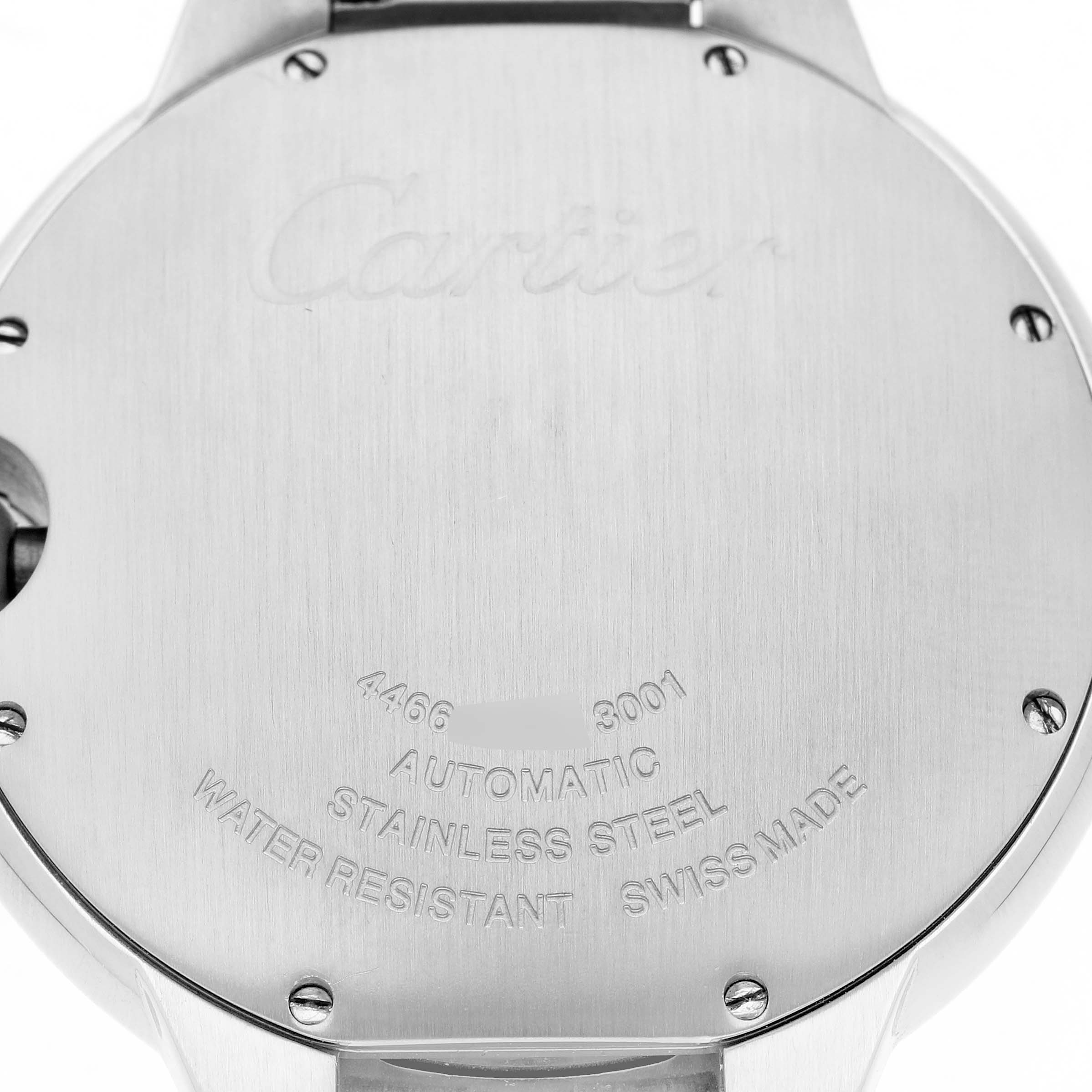 The image shows the back of a Cartier Ballon Bleu W69012Z4 Men's Stainless Steel Silver Dial watch, highlighting engravings and screws.