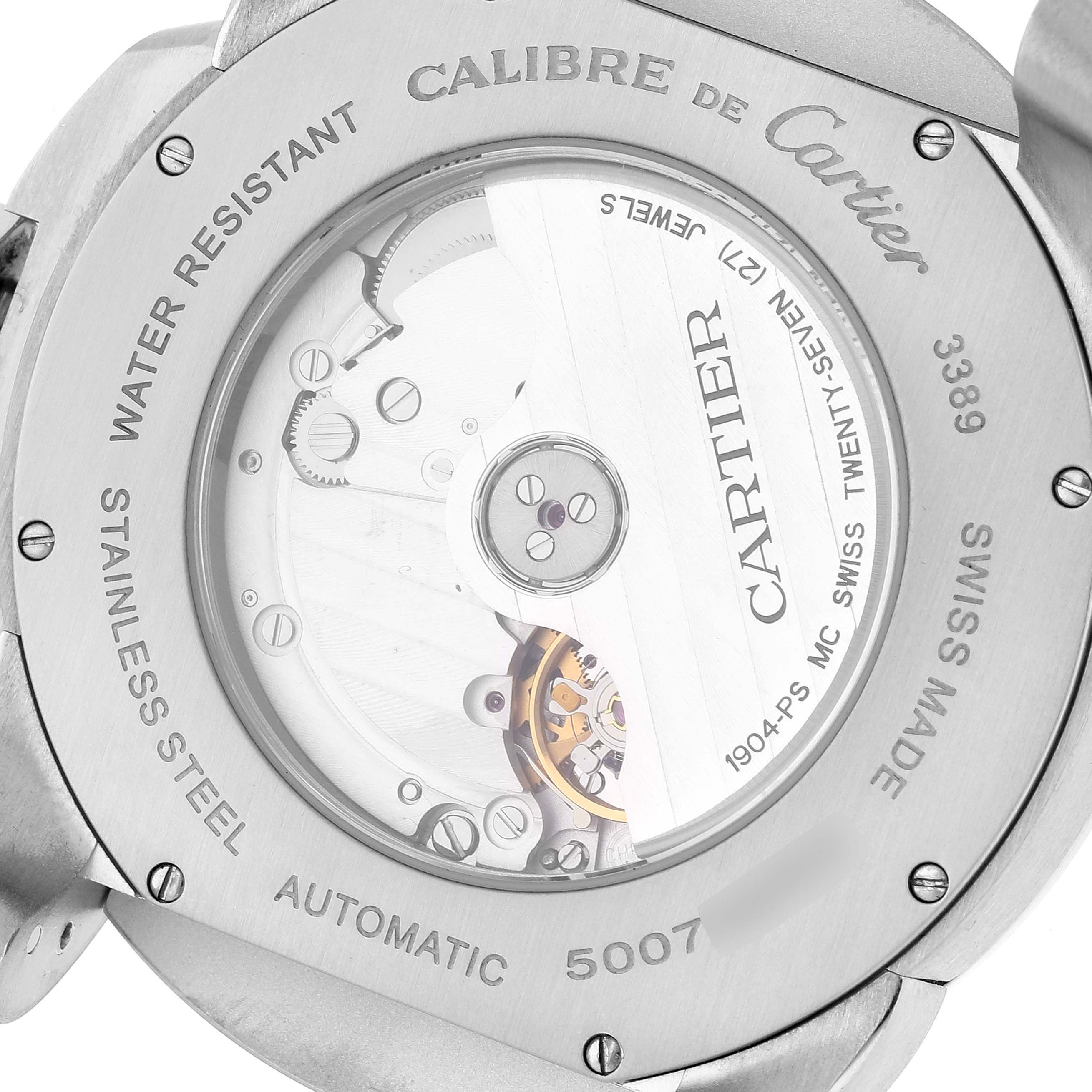 The image shows the back of a Calibre de Cartier watch by Cartier, highlighting its automatic movement, stainless steel casing, and inscriptions.