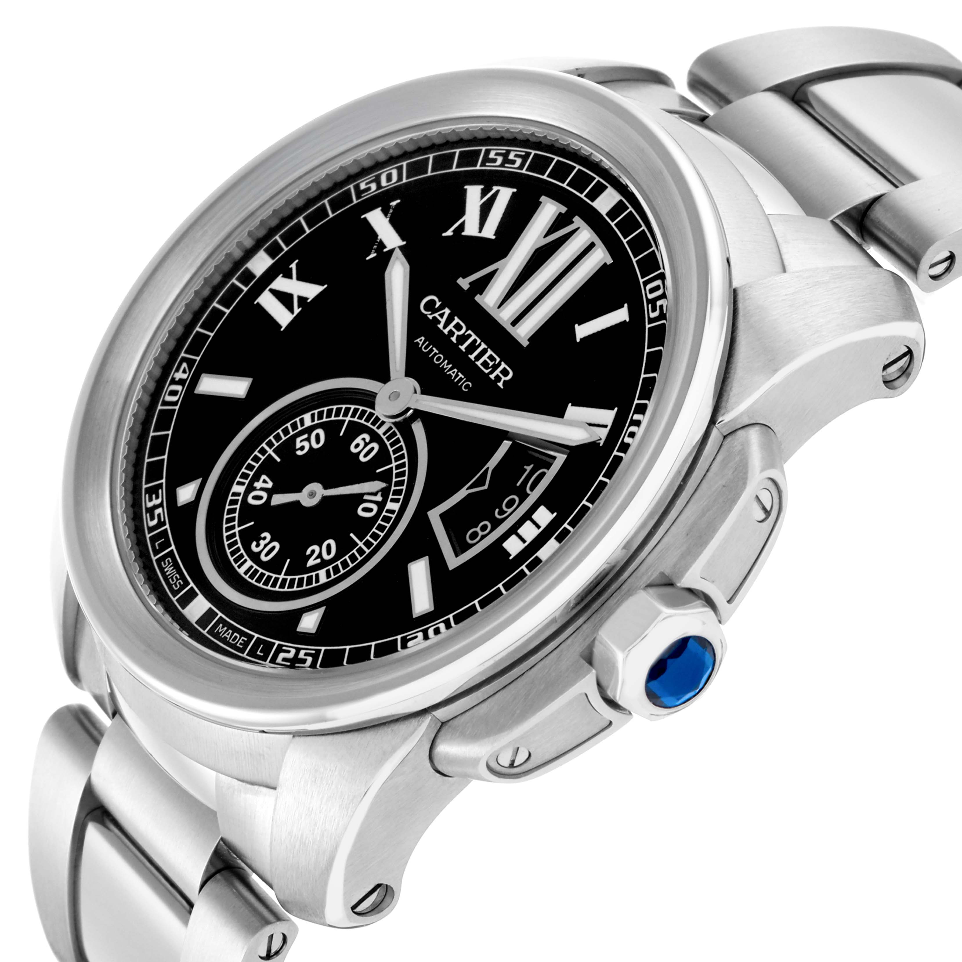 The Calibre de Cartier watch is shown at an angle highlighting the face, bezel, and part of the metal bracelet.
