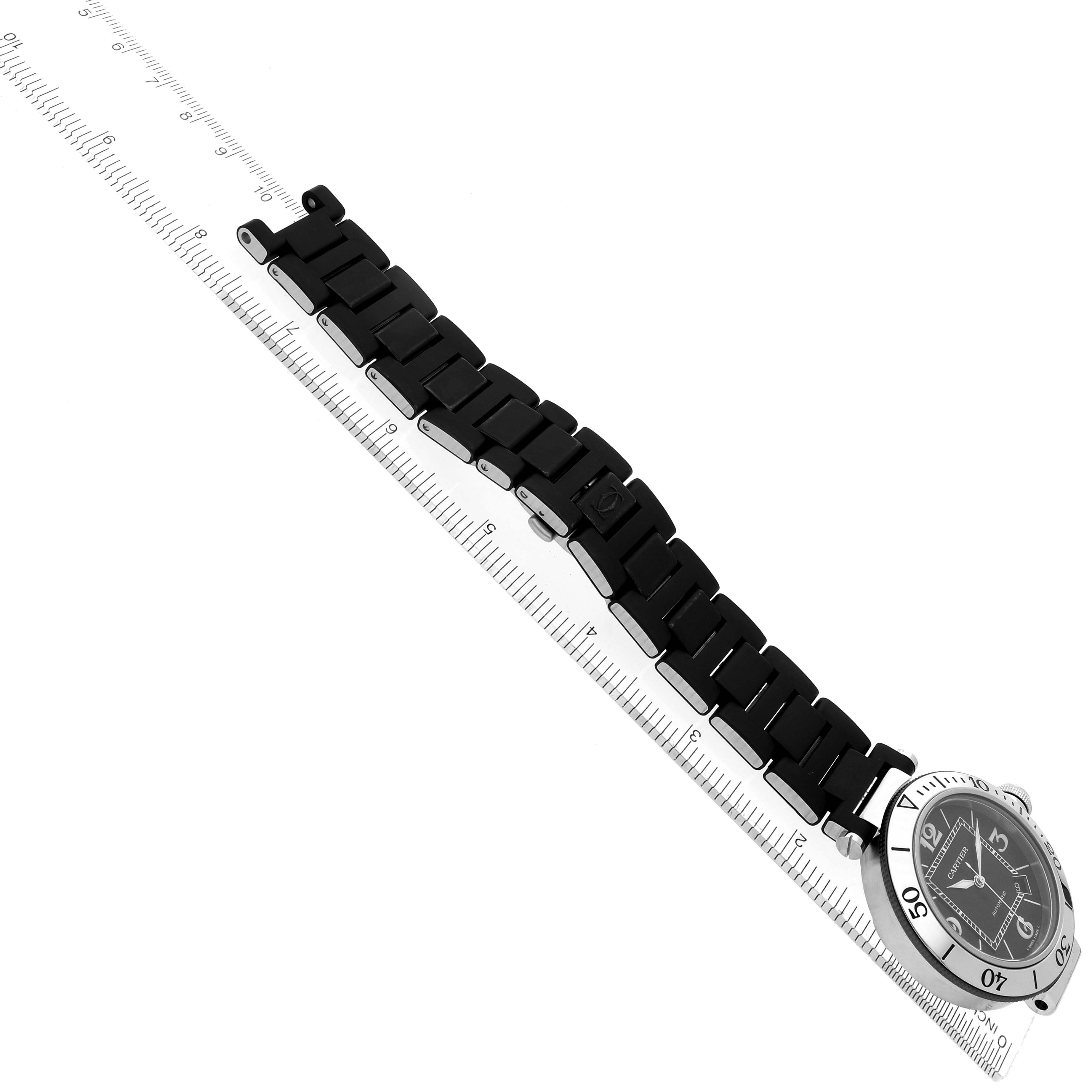 The Cartier Pasha W31077U2 Men
s Stainless Steel Black Dial W31077U2 Men
s Stainless Steel Black Dial watch is shown at an angle displaying its face and full linked bracelet alongside a ruler.