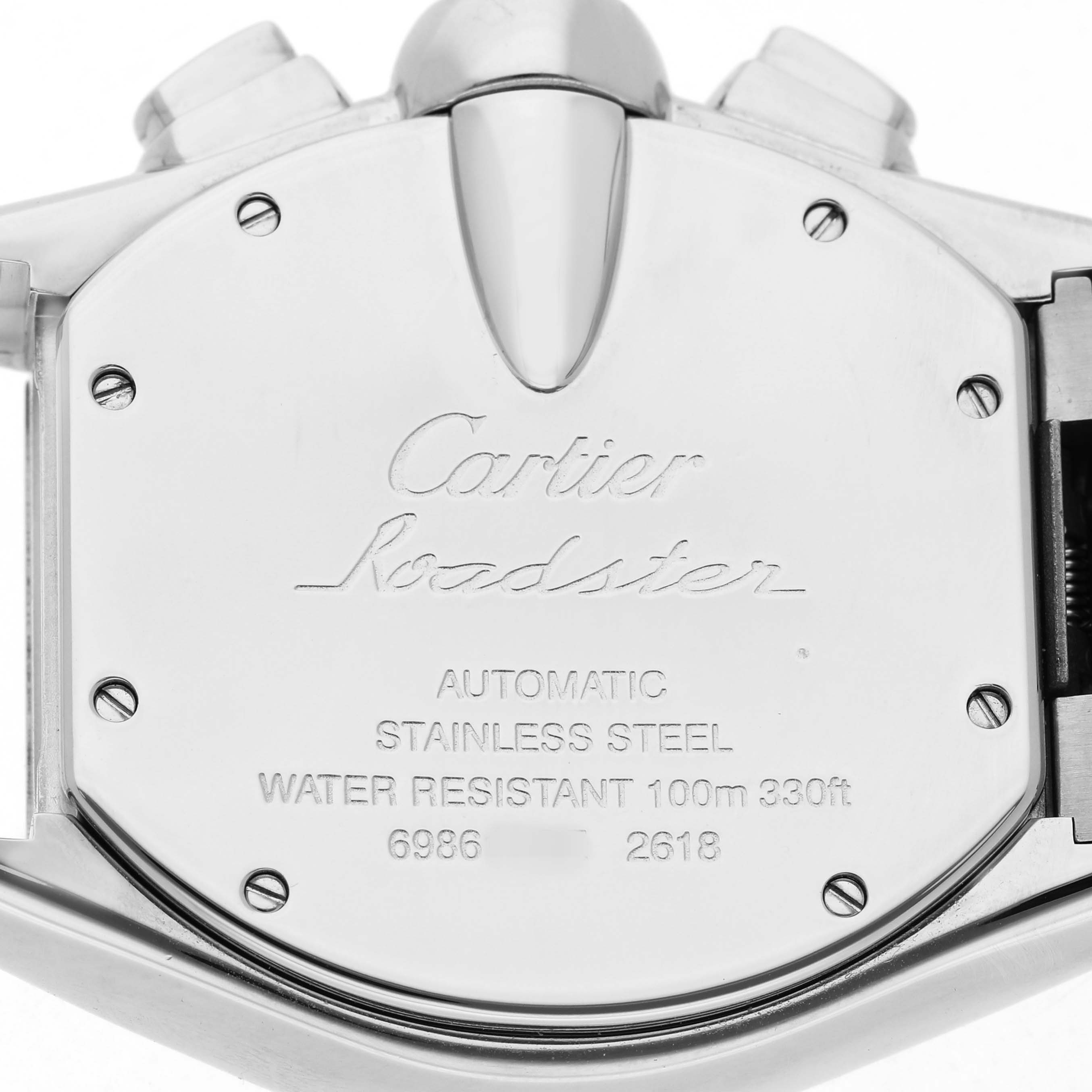 The image shows the back case of a Cartier Roadster W62019X6 Men's Stainless Steel Silver Dial watch, highlighting its details and engravings.
