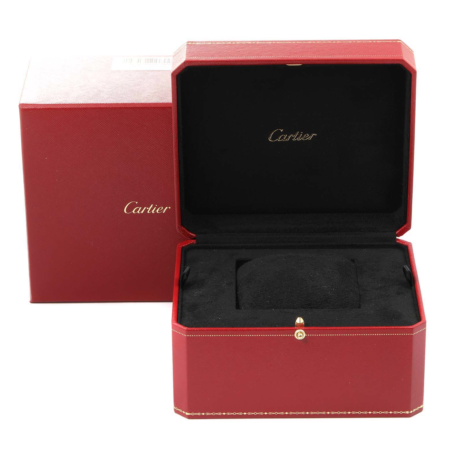 The image shows an open Cartier Santos W20121U2 Men
s Stainless Steel Silver Dial W20121U2 Men
s Stainless Steel Silver Dial watch box, revealing a black interior and red exterior.