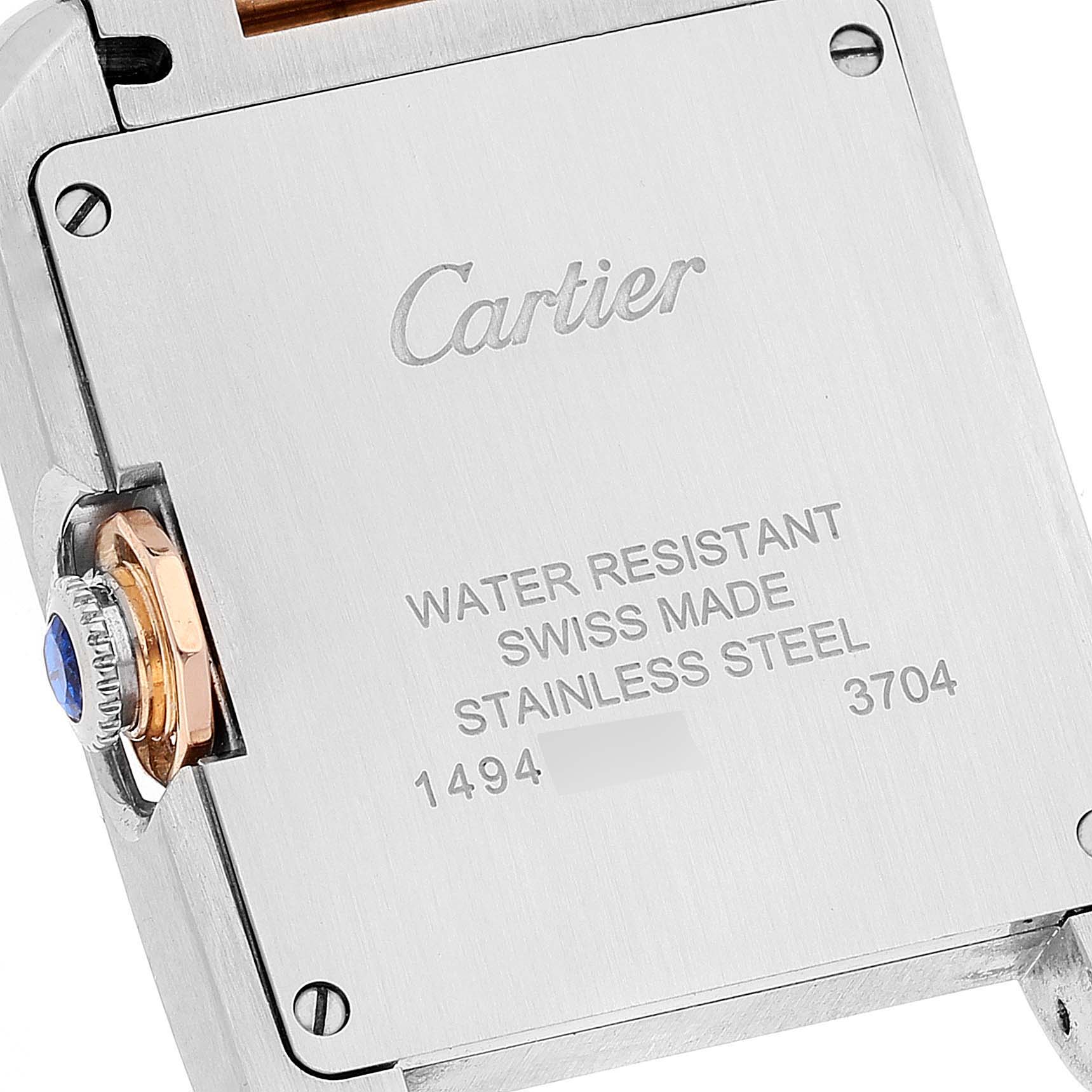 The image shows the back case of a Cartier Tank Anglaise WT100032 Women
s Steel and Gold (two tone) Silver Dial WT100032 Women
s Steel and Gold (two tone) Silver Dial watch, highlighting the brand engraving and details on water resistance and material.