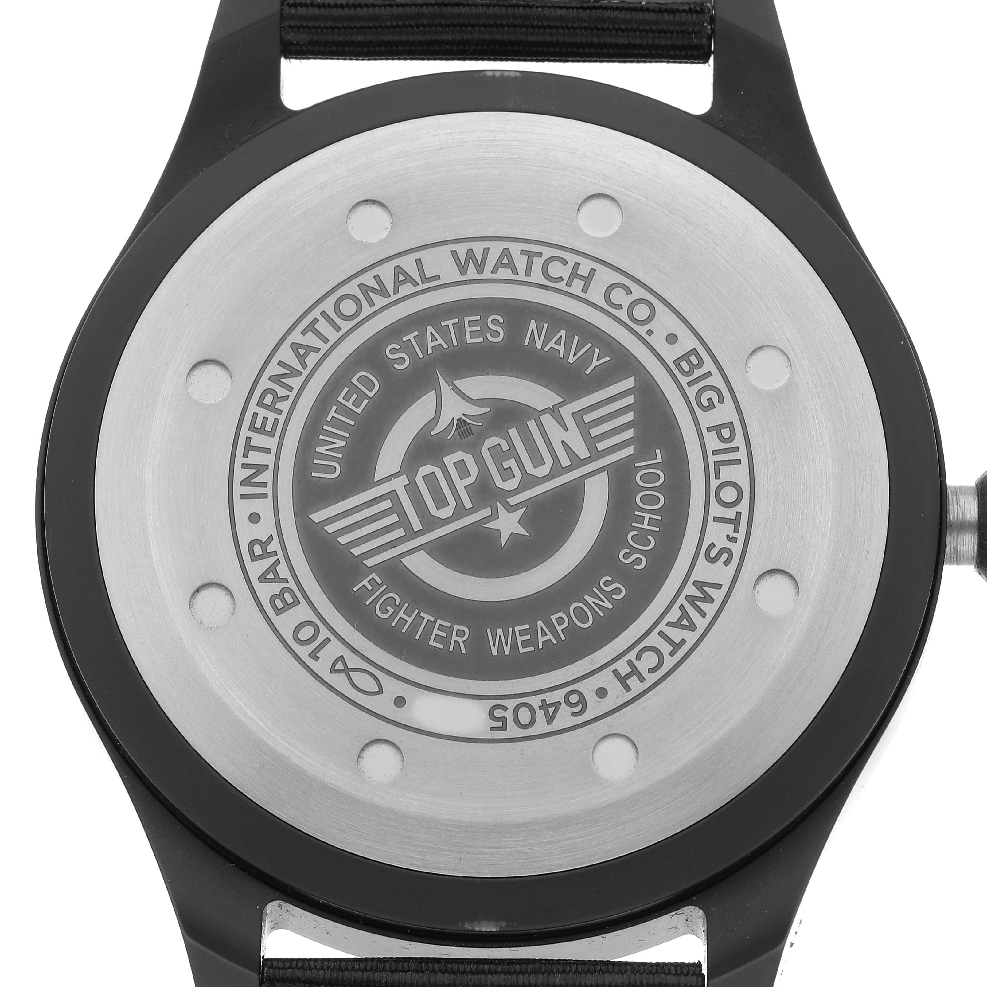 The image shows the back of an IWC Pilot IW329801 Men's Ceramic Black Dial IW329801 Men's Ceramic Black Dial model watch, featuring Top Gun and US Navy engravings.