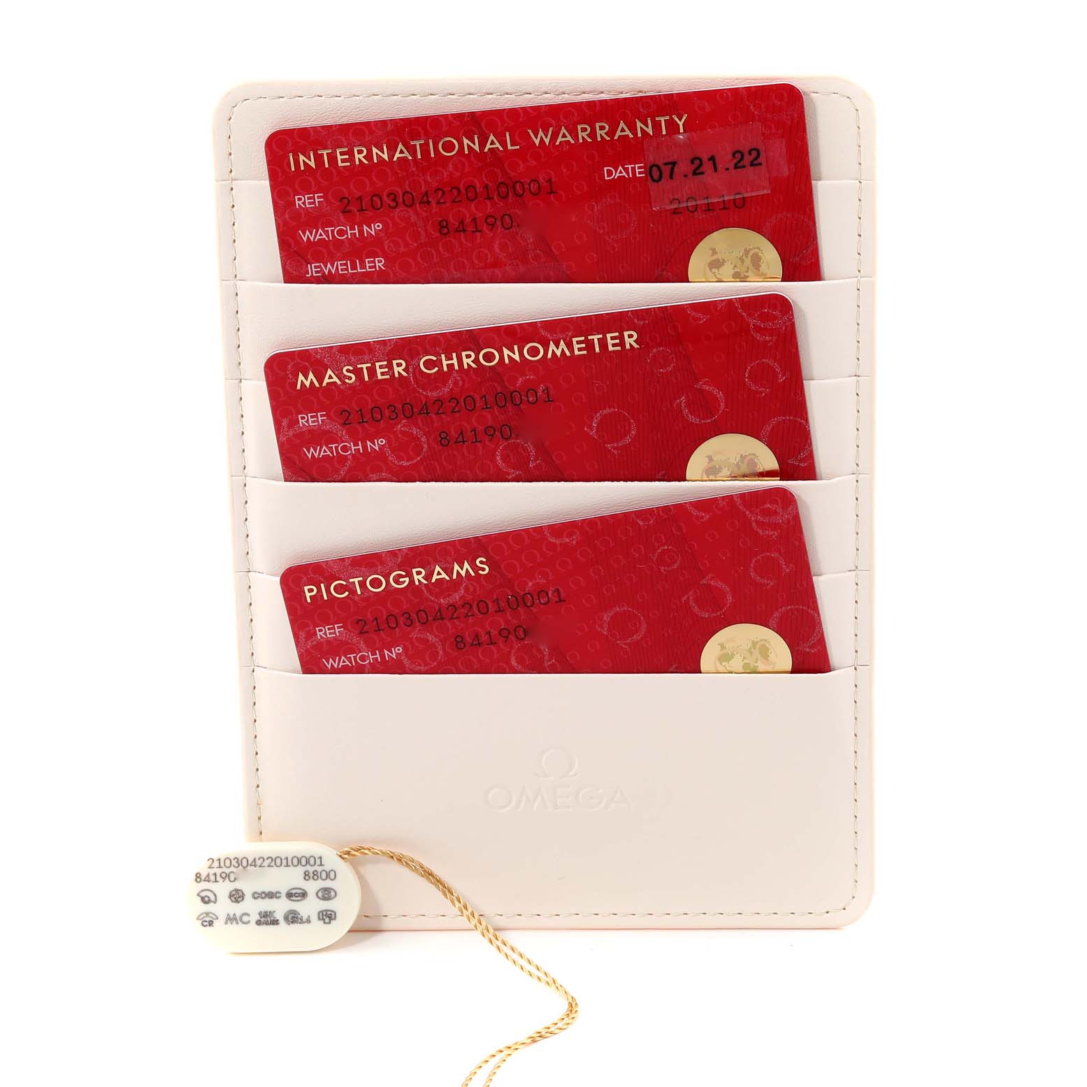 The image shows warranty cards and a hang tag for an Omega Seamaster 210.30.42.20.10.001 Men's Stainless Steel Green Dial 210.30.42.20.10.001 Men's Stainless Steel Green Dial watch, placed in a white Omega cardholder.