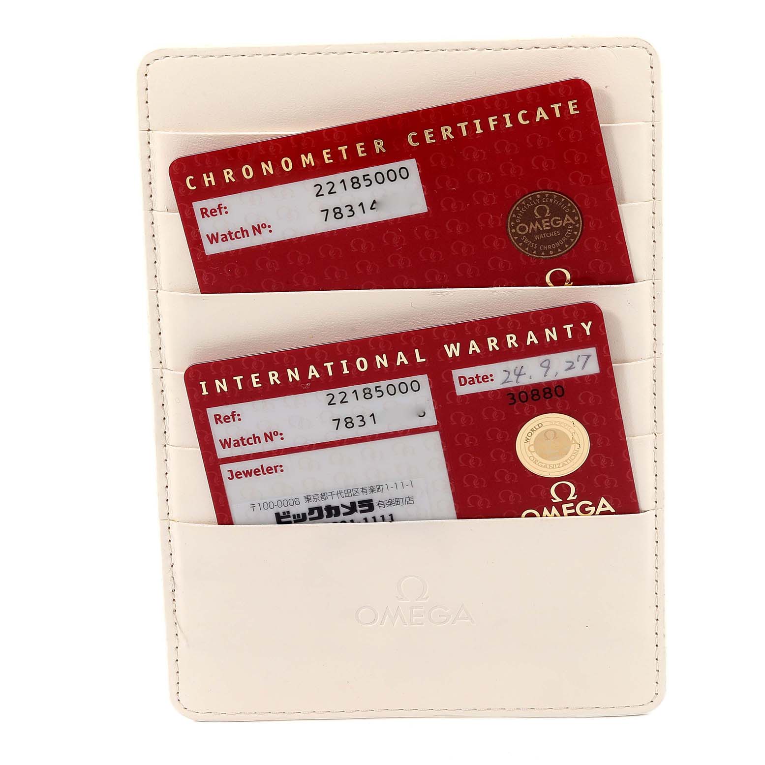 The image shows a white Omega cardholder containing the Chronometer Certificate and International Warranty cards for the Planet Ocean model.
