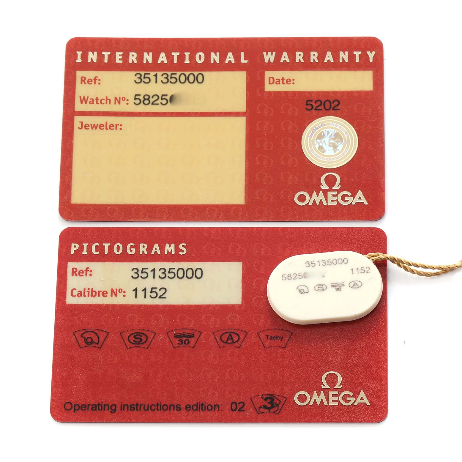 The image shows the warranty and pictogram cards for an Omega Speedmaster 3513.50.00 Men
s Stainless Steel Black Dial 3513.50.00 Men
s Stainless Steel Black Dial watch, along with a tag, from a top-down angle.