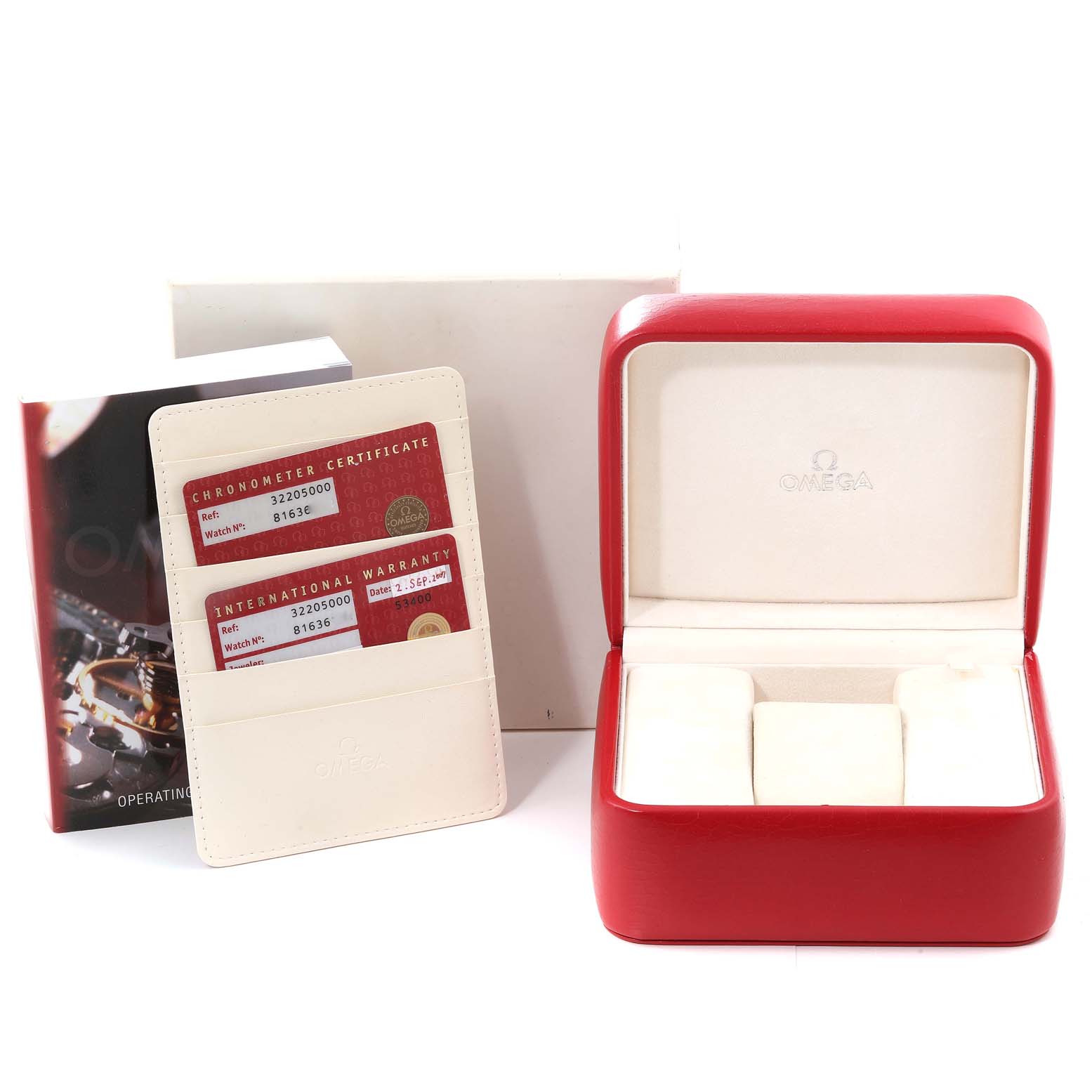 The image shows an Omega Speedmaster 3220.50.00 Men
s Stainless Steel Black Dial 3220.50.00 Men
s Stainless Steel Black Dial watch box along with warranty cards and an operating manual, taken from a frontal angle.