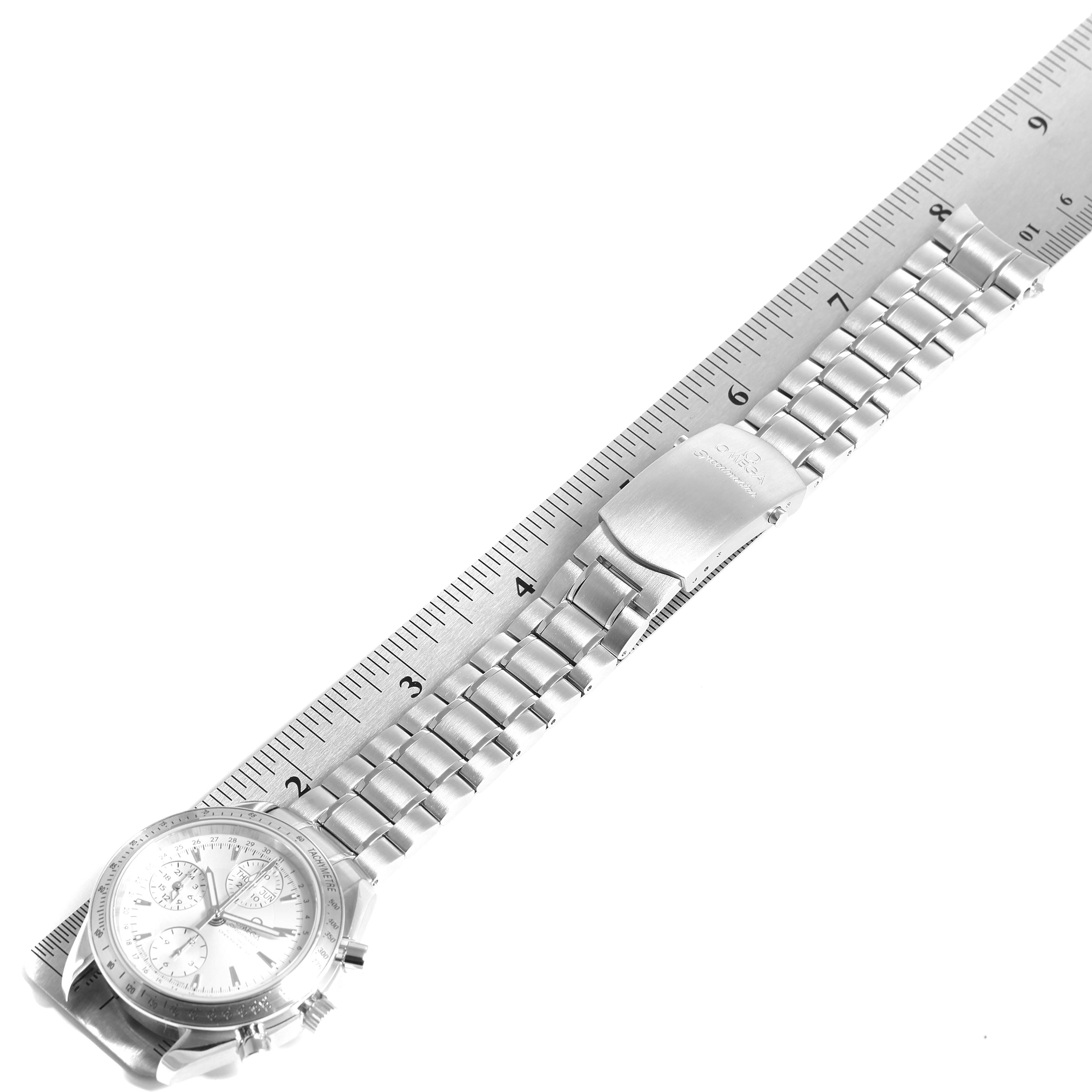 An Omega Speedmaster 3521.30.00 Men's Stainless Steel Silver Dial 3521.30.00 Men's Stainless Steel Silver Dial watch is shown at a three-quarter angle with its bracelet laid atop a ruler.