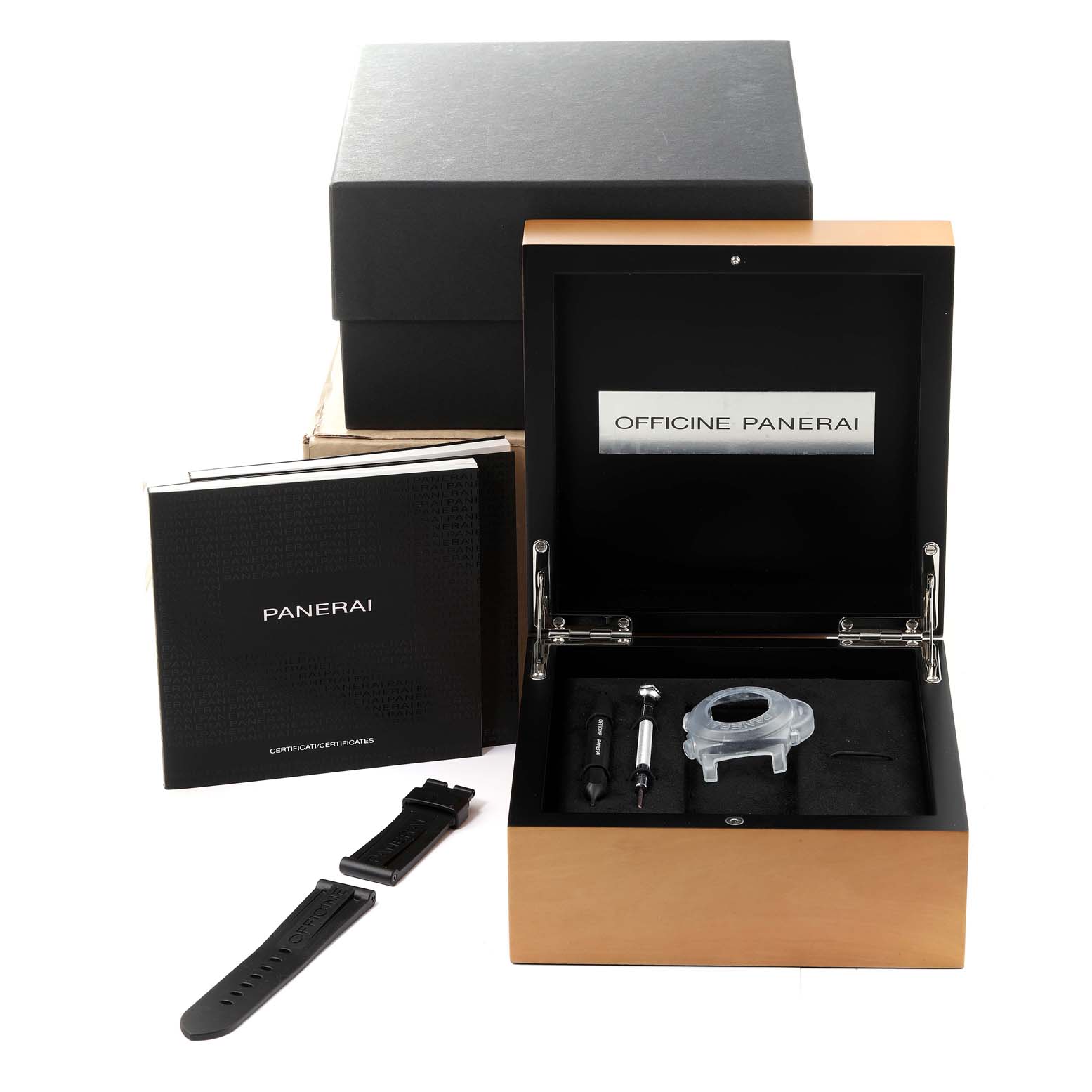 The image shows the accessories and packaging for a Panerai Luminor PAM00524 Men
s Stainless Steel Black Dial PAM00524 Men
s Stainless Steel Black Dial watch including a box, booklet, tools, and an extra strap.