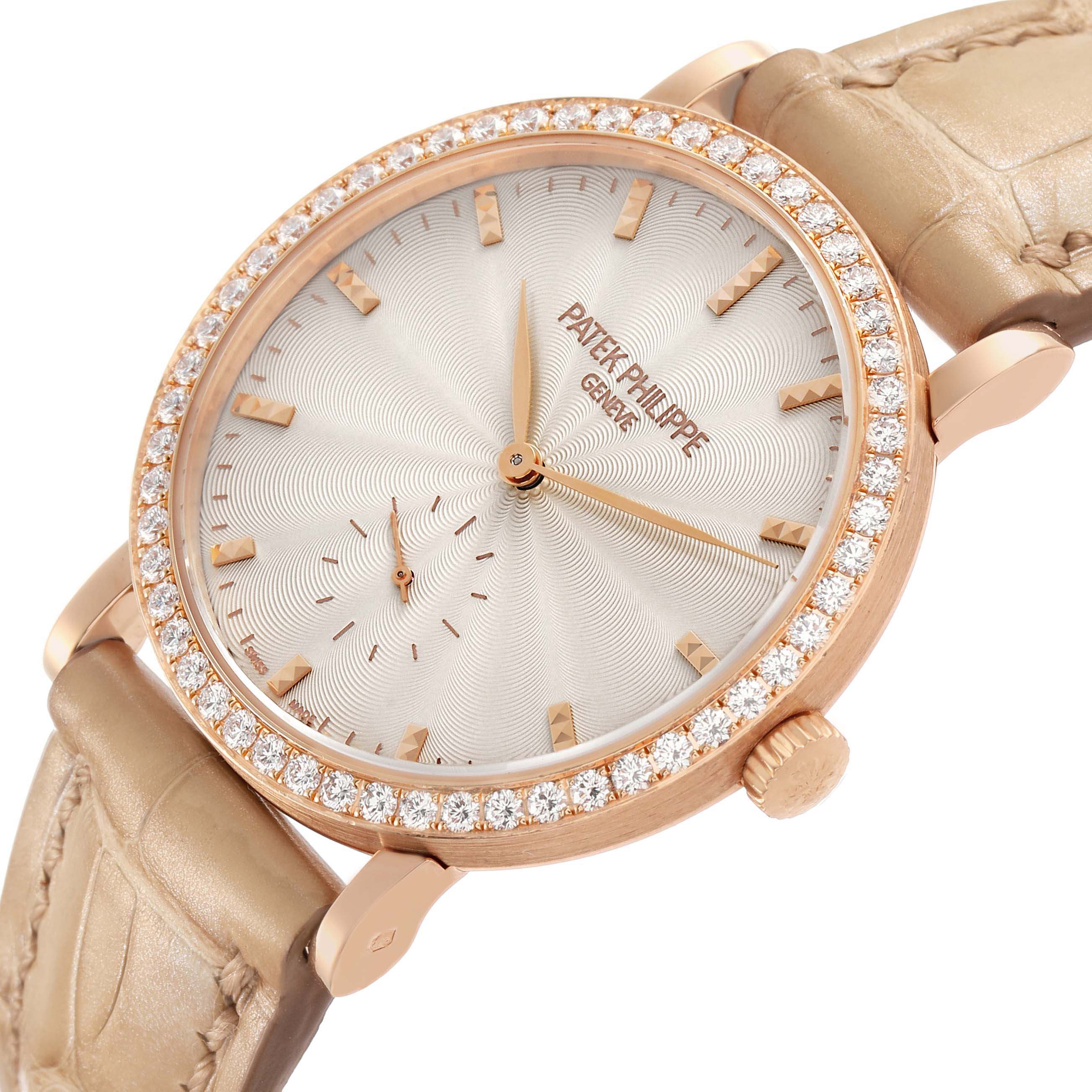 The Patek Philippe Calatrava 7120R-001 Women's Rose Gold Beige Dial watch is shown at an angled view, displaying its face, diamond-set bezel, and strap attachment.