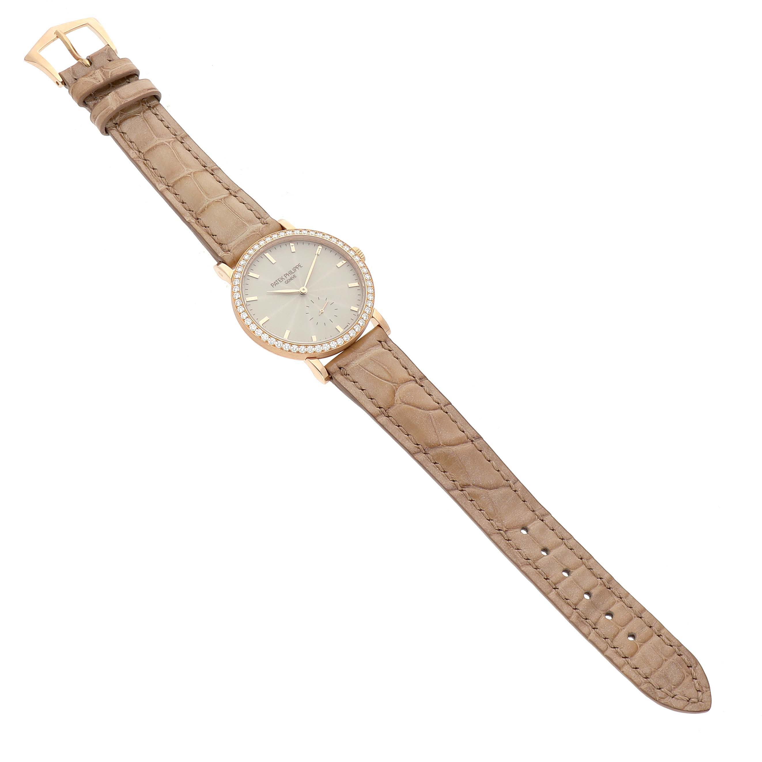 The image shows a top view of a Patek Philippe Calatrava 7120R-001 Women's Rose Gold Beige Dial watch, displaying its beige leather strap and diamond-set bezel.