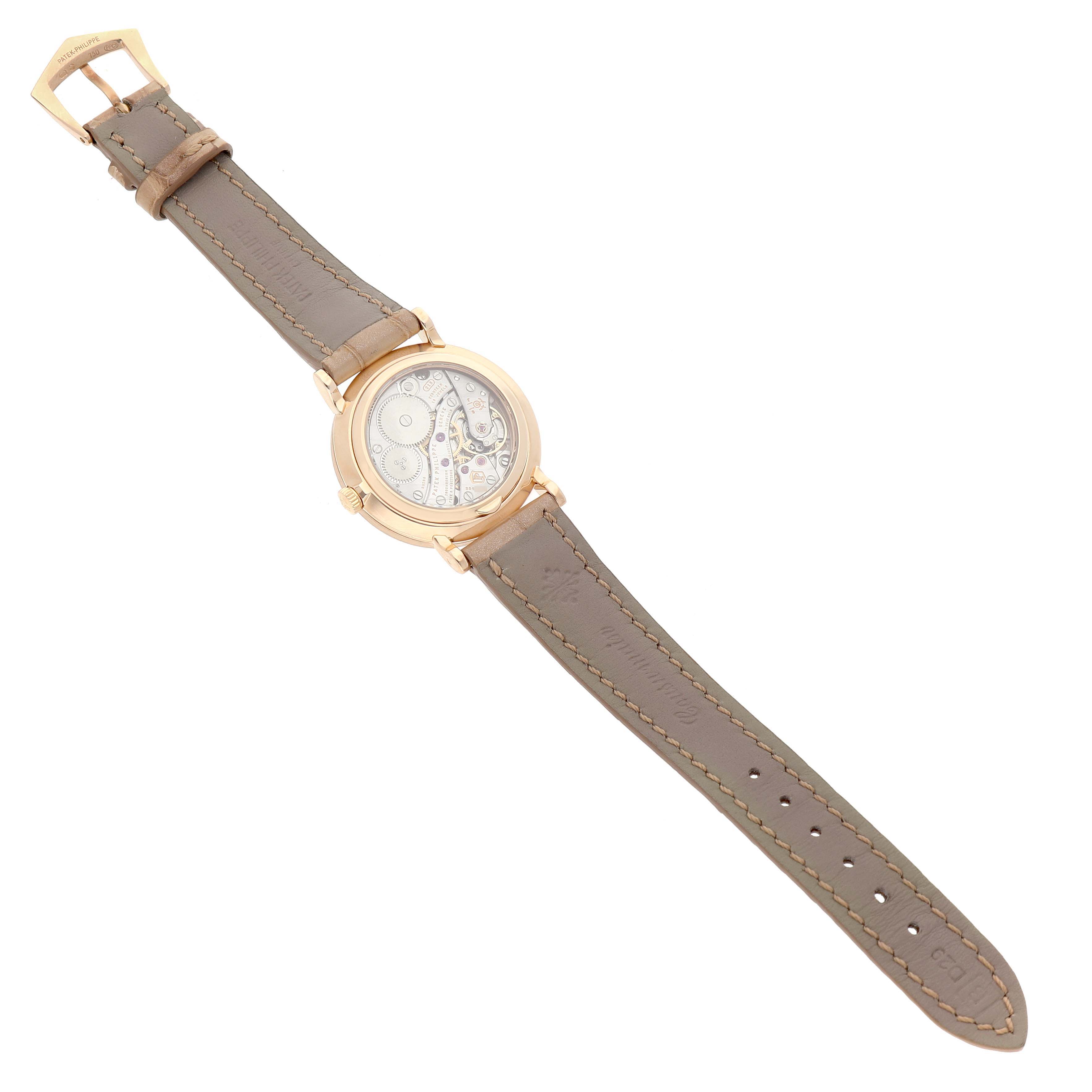 The Patek Philippe Calatrava 7120R-001 Women's Rose Gold Beige Dial watch is shown from the back, highlighting its movement and leather strap.