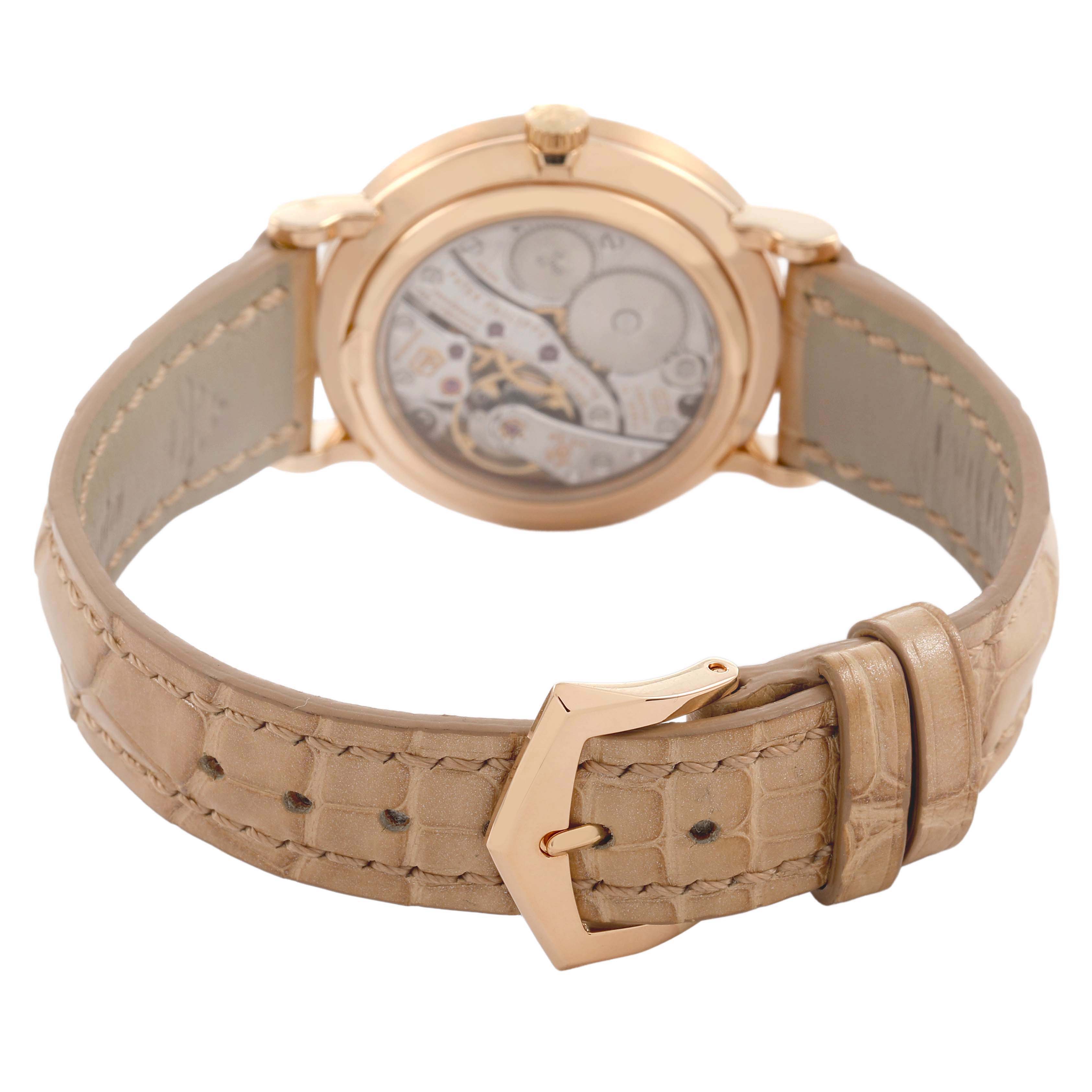 The image shows the back view of a Patek Philippe Calatrava 7120R-001 Women's Rose Gold Beige Dial watch, highlighting the transparent case back and beige leather strap with a buckle.