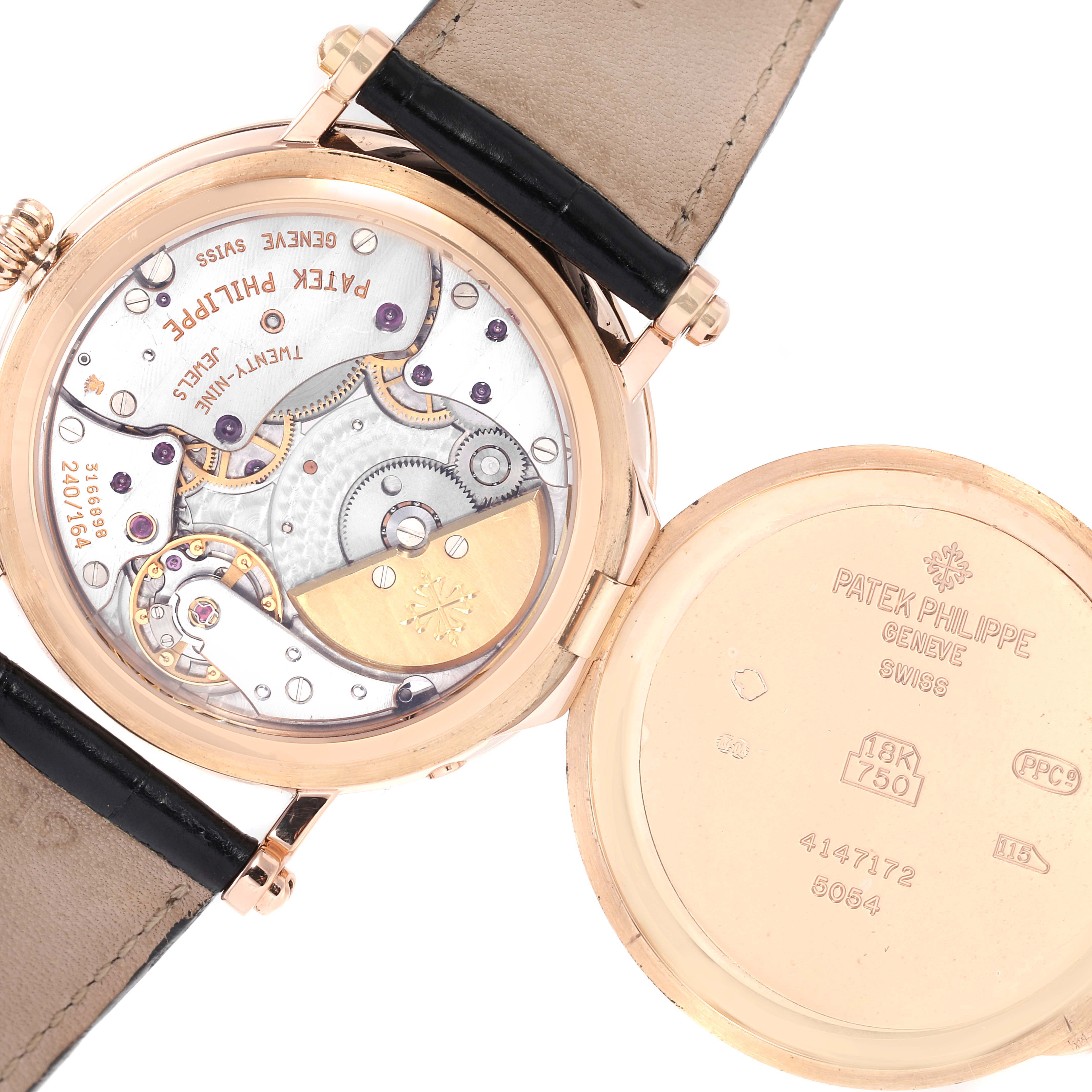 The image shows the back view of the Patek Philippe Complications 5054 Men's Rose Gold White Dial 5054 Men's Rose Gold White Dial watch, showcasing its intricate movement and open case back.