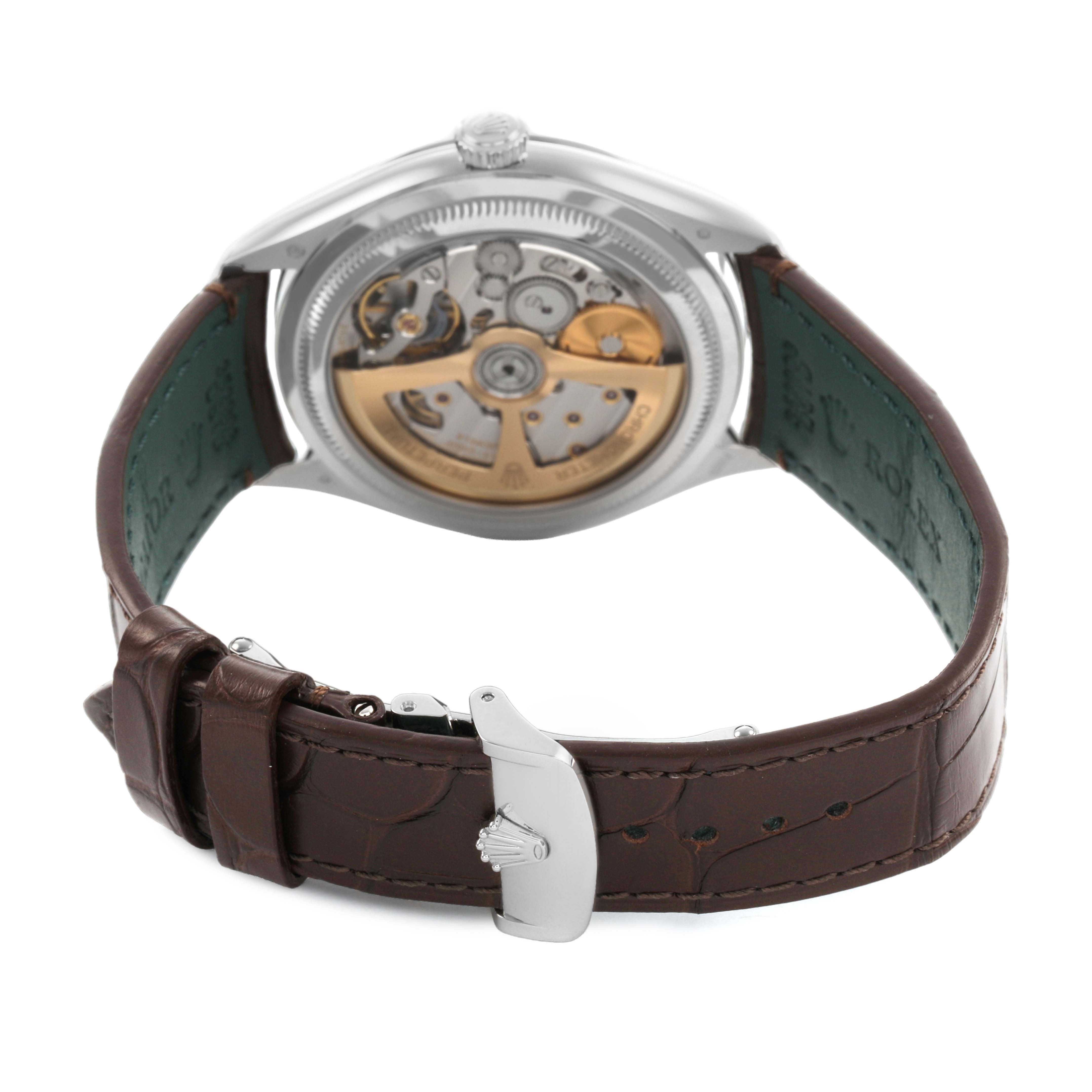 The image shows the back view of a Rolex 1908 52506 Men's Platinum Blue Dial, highlighting the movement and brown leather strap with a clasp.