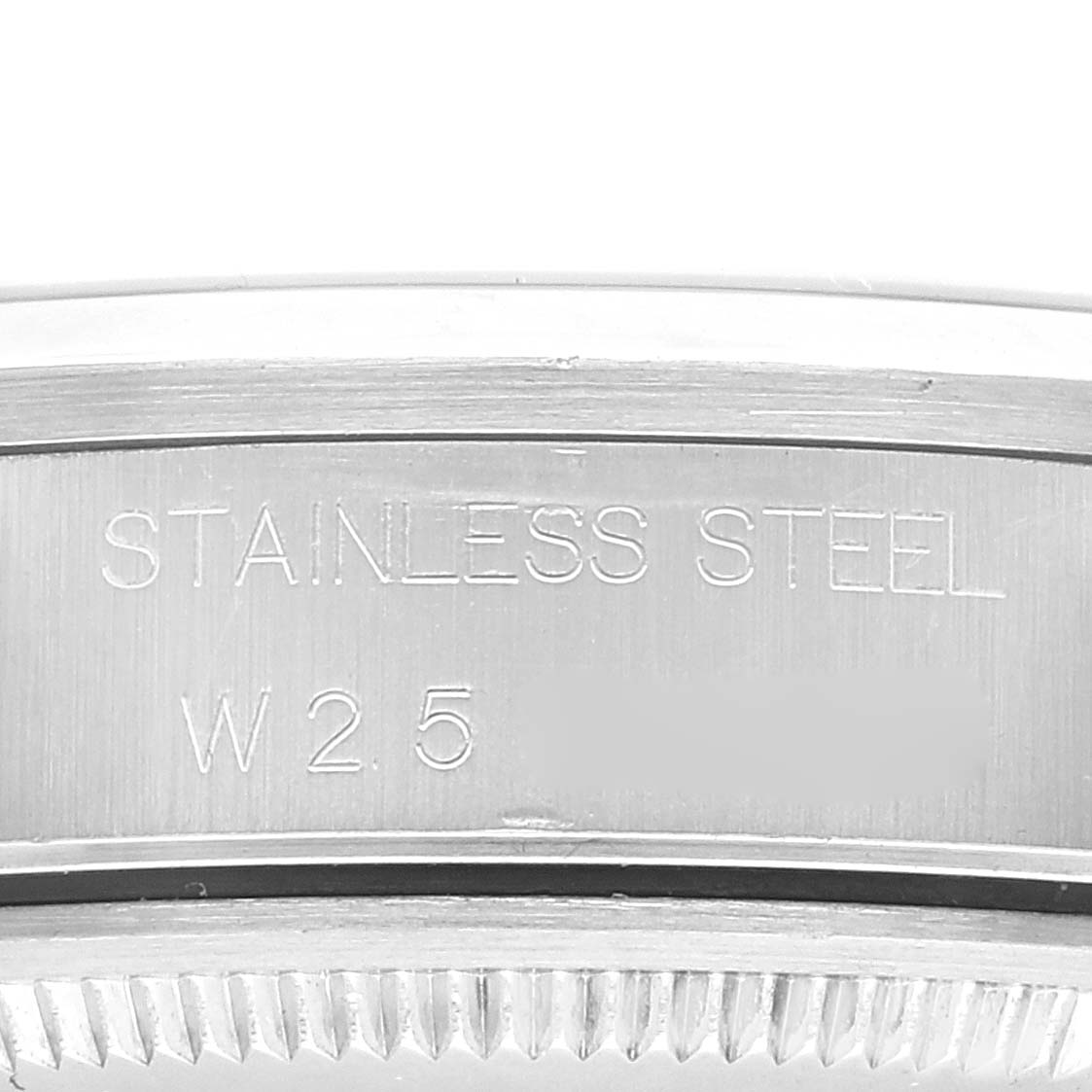 This close-up image shows the stainless steel back of a Rolex Air-King 14000 Men's Stainless Steel Black Dial 14000 Men's Stainless Steel Black Dial watch, highlighting engravings and part of the bezel.
