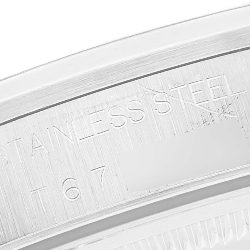 This close-up image shows part of the stainless steel casing of a Rolex Air-King 14000 Men's Stainless Steel White Dial 14000 Men's Stainless Steel White Dial watch, with focus on an engraved section.