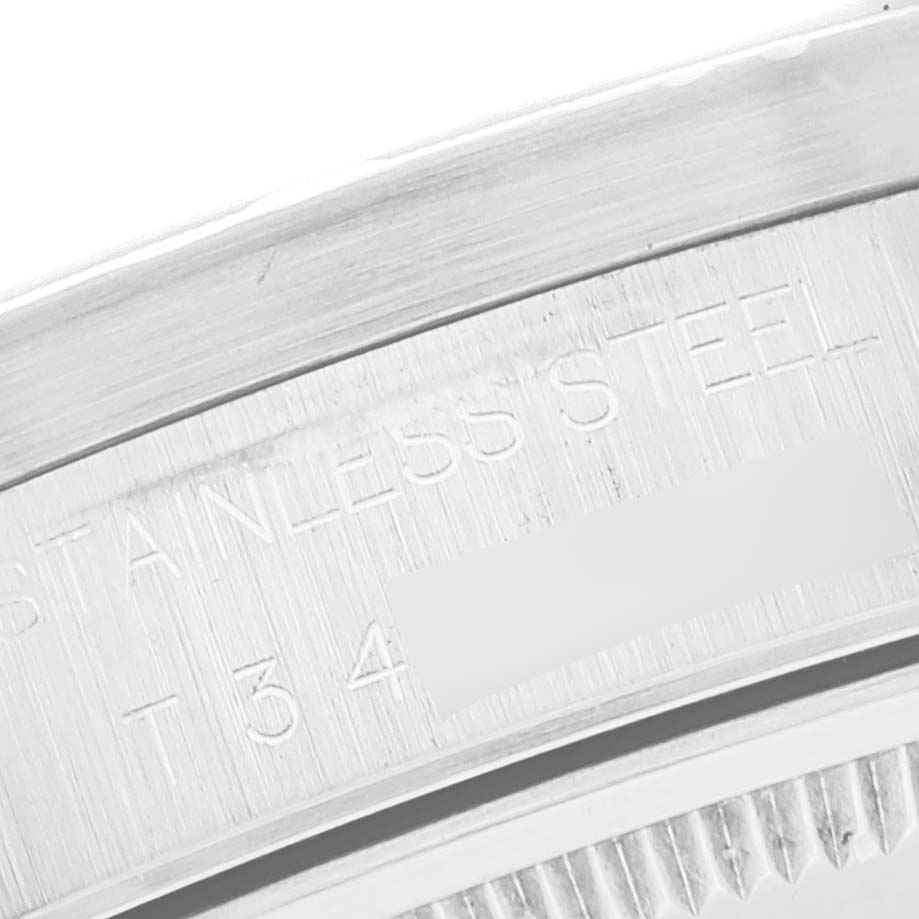 This image shows a close-up of the edge of the case back for the Rolex Air-King 14010 Men's Stainless Steel White Dial 14010 Men's Stainless Steel White Dial watch, highlighting the "STAINLESS STEEL" engraving.