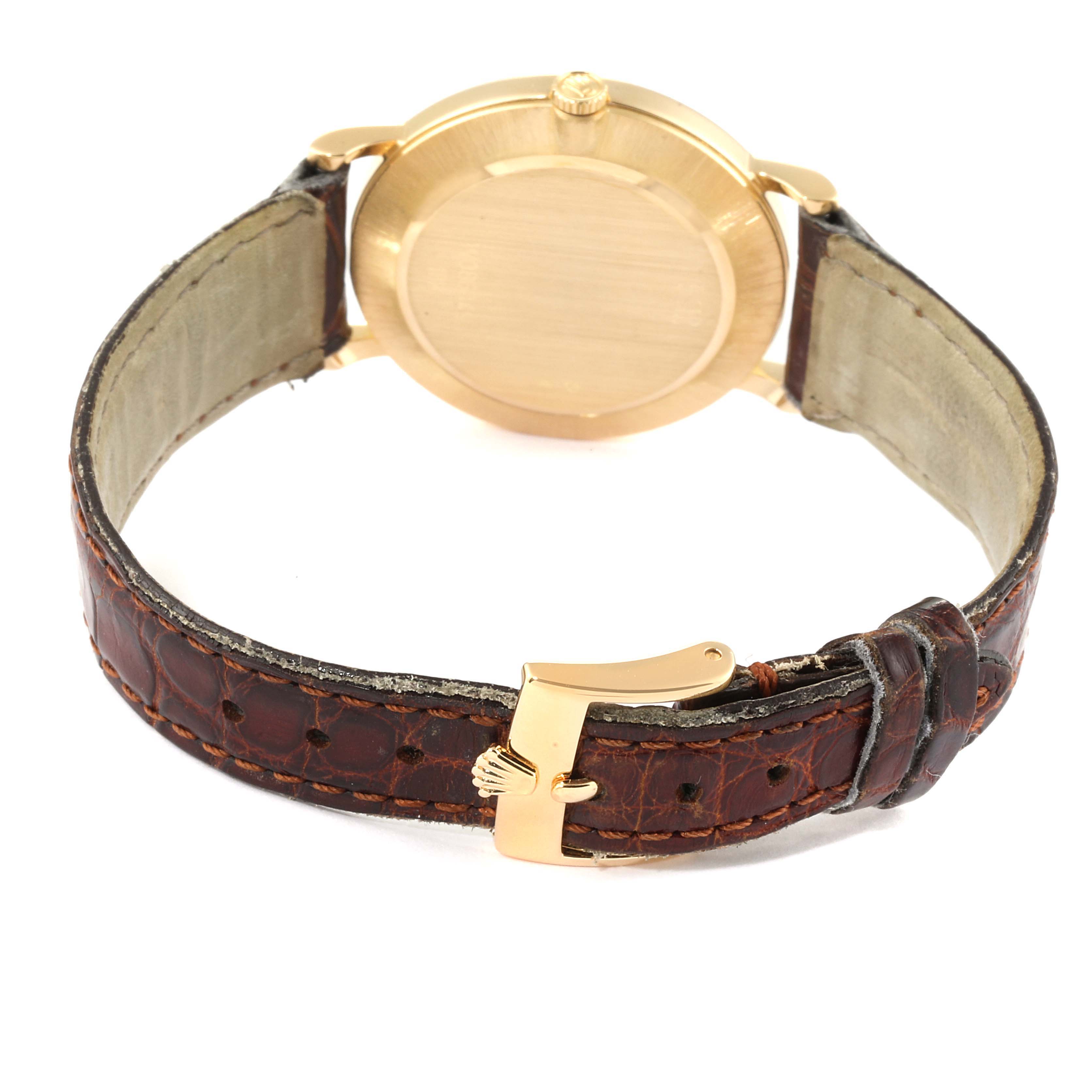 The image shows the back of a Rolex Cellini 5112 Men's Yellow Gold Mother of Pearl Dial 5112 Men's Yellow Gold Mother of Pearl Dial watch, highlighting its case, crown, and leather strap with the Rolex clasp.