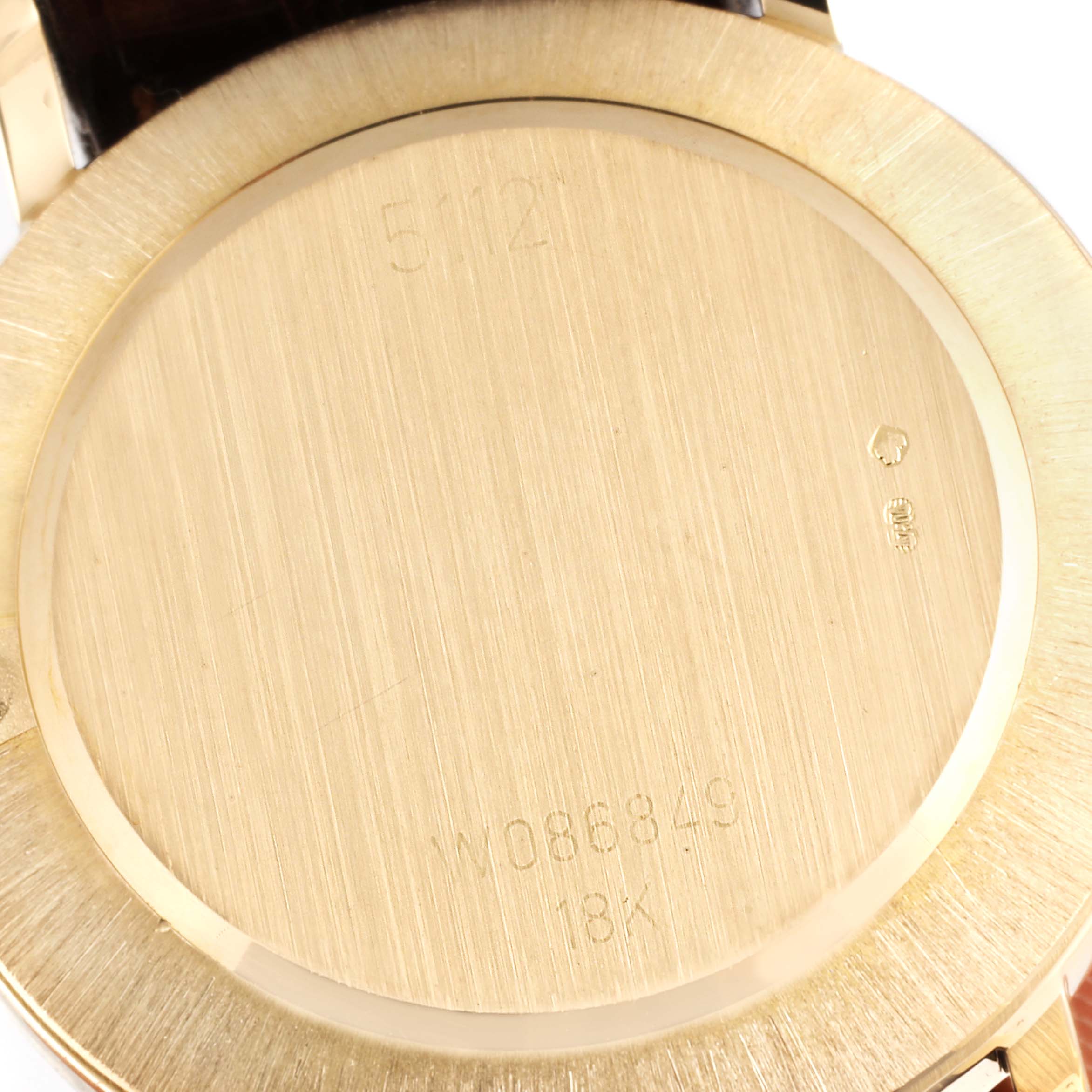 This image shows the back case of a Rolex Cellini 5112 Men's Yellow Gold Mother of Pearl Dial 5112 Men's Yellow Gold Mother of Pearl Dial watch, highlighting engravings and hallmarks.