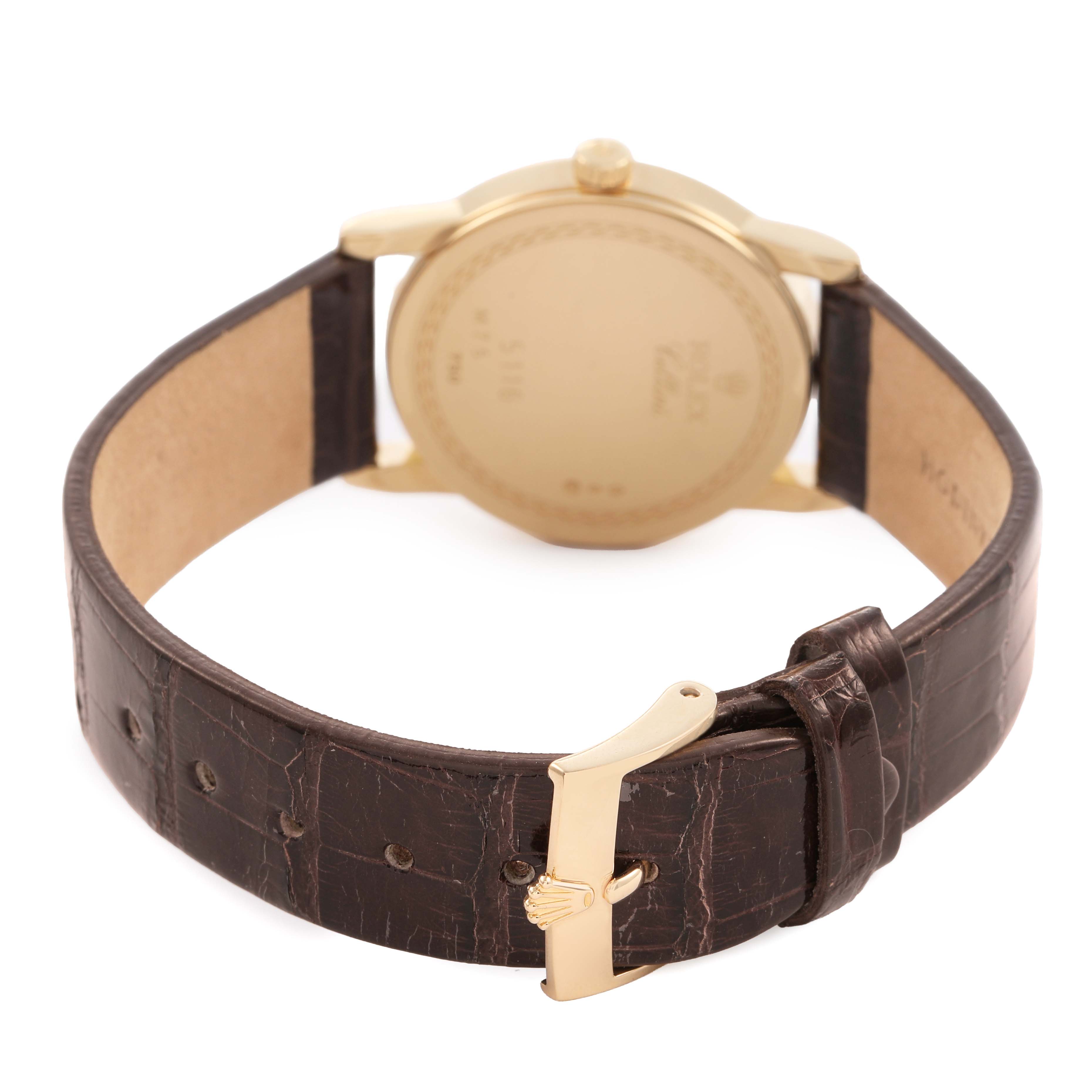 The image shows the back of a Rolex Cellini 5116/8 Men's Yellow Gold Silver Dial watch, highlighting its brown leather strap and gold buckle.