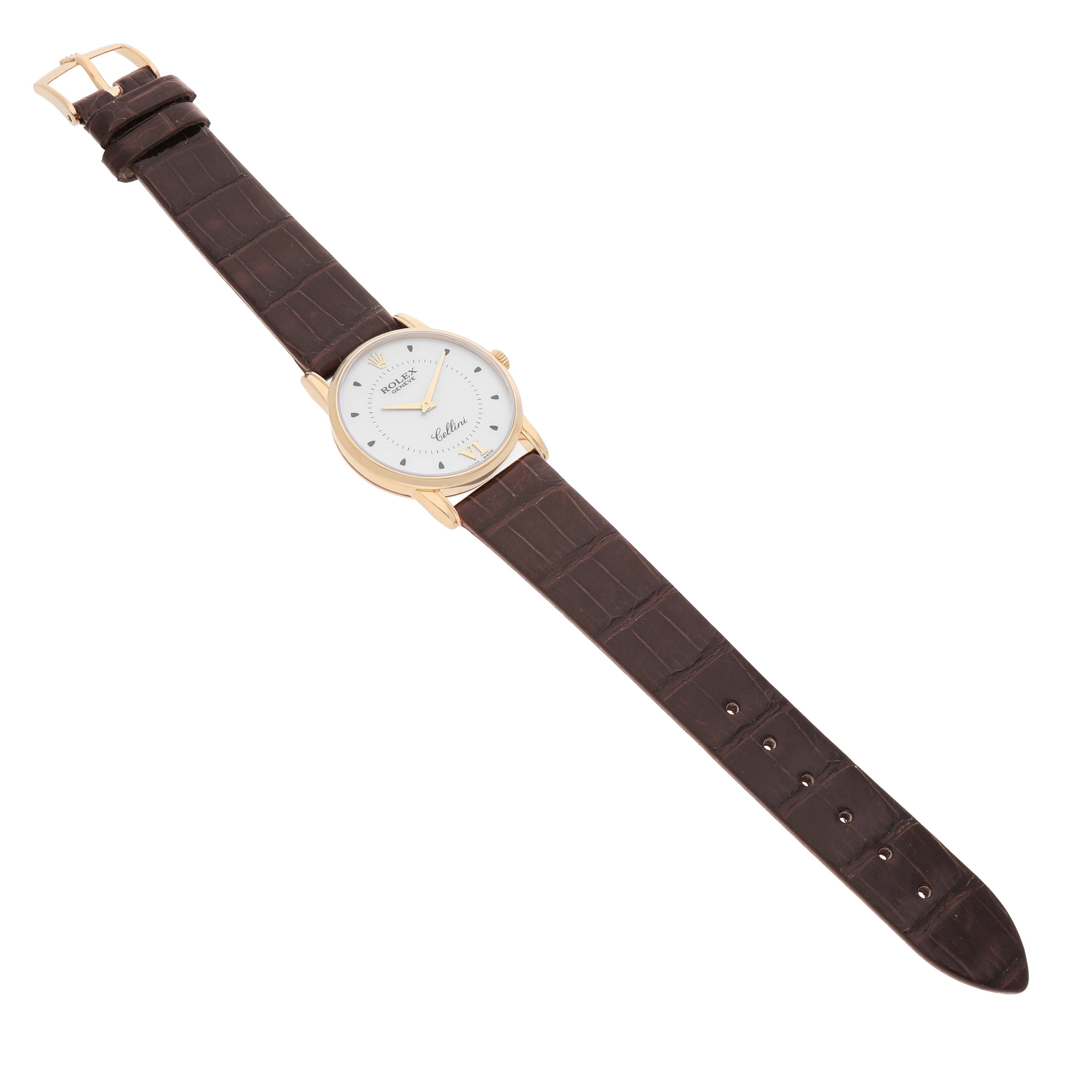 The Rolex Cellini 5116/8 Men's Yellow Gold Silver Dial watch is shown from a slightly elevated angle, displaying the full leather strap and round dial.
