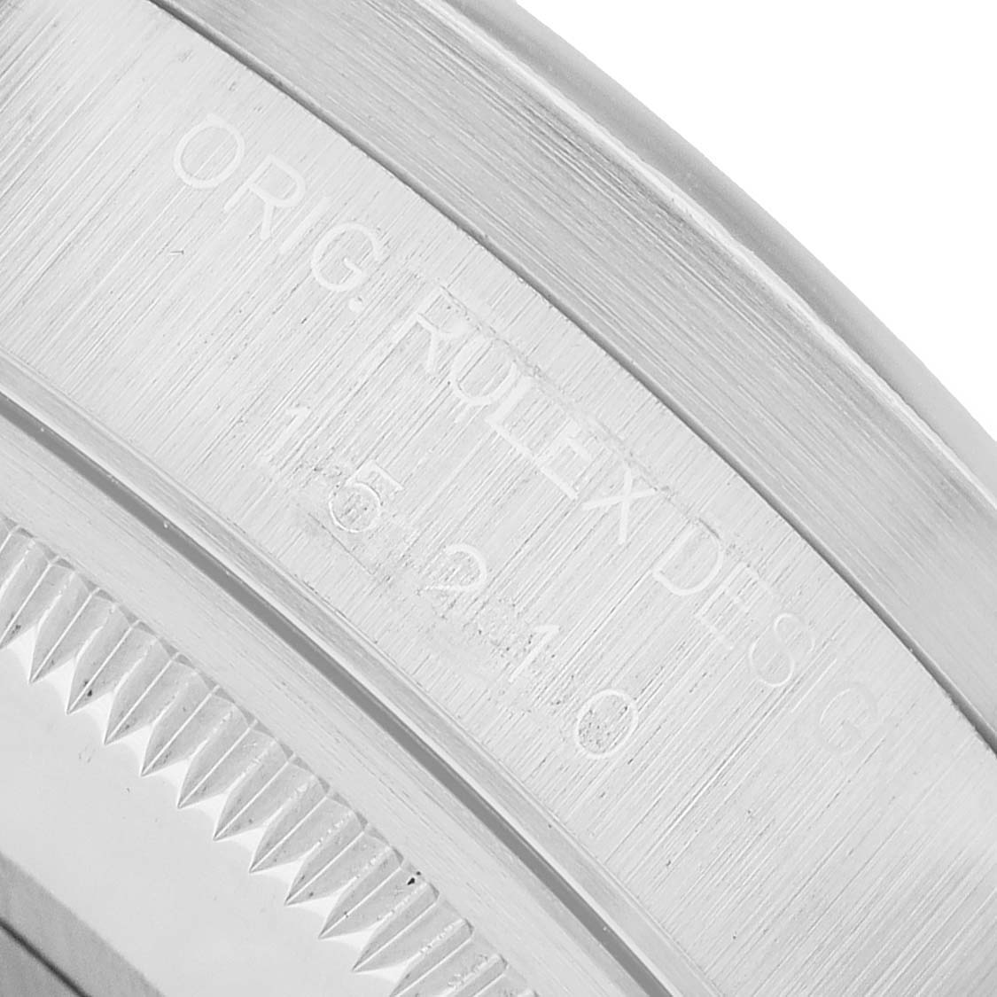 The image shows a close-up of the engraved edge on a Rolex Date 15210 Men's Stainless Steel Black Dial watch's bezel.