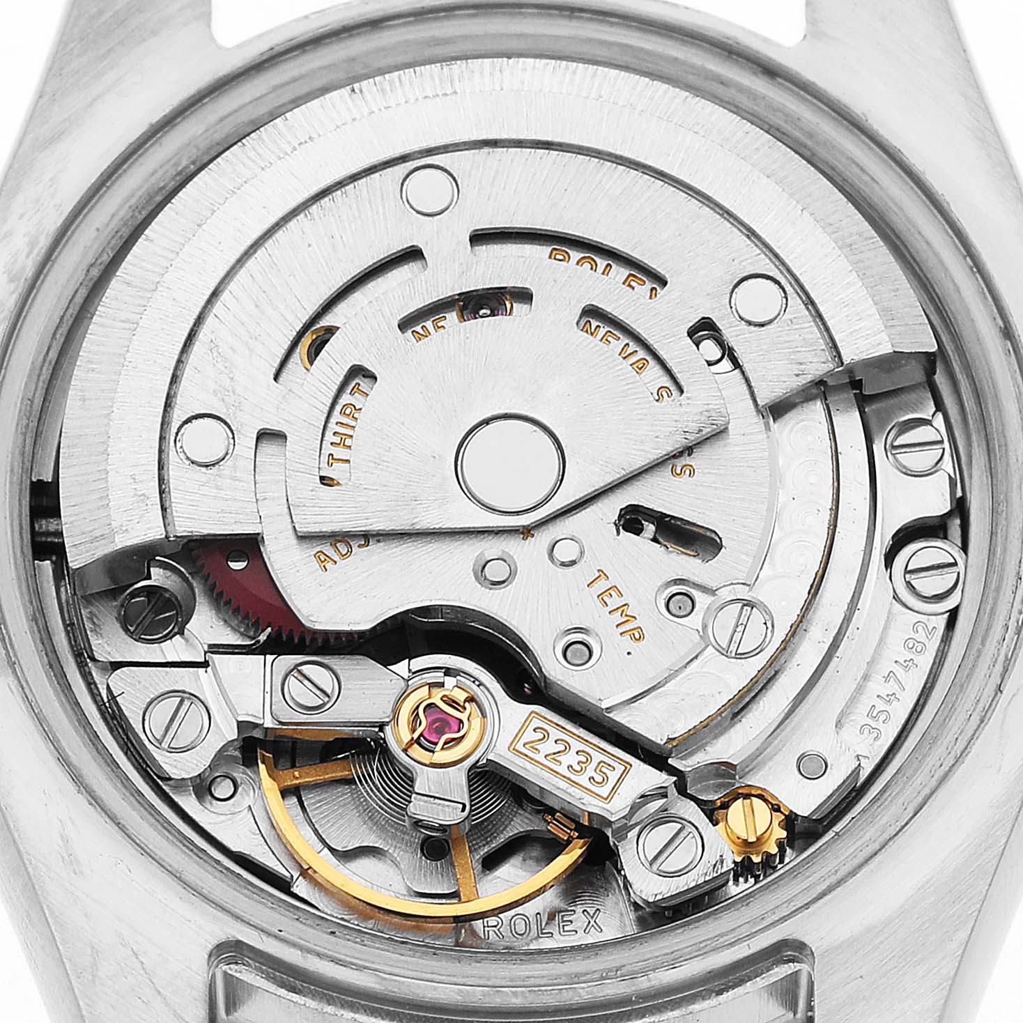 The image shows the movement of a Rolex Datejust 179384 Women's Stainless Steel Silver Dial watch from a back angle, highlighting its intricate components.