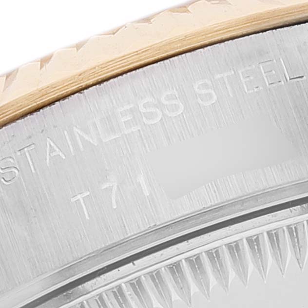 This image shows a close-up of the caseback edge and part of the fluted bezel of the Rolex Datejust 69173 Women's Steel and Gold (two tone) Blue Dial 69173 Women's Steel and Gold (two tone) Blue Dial.