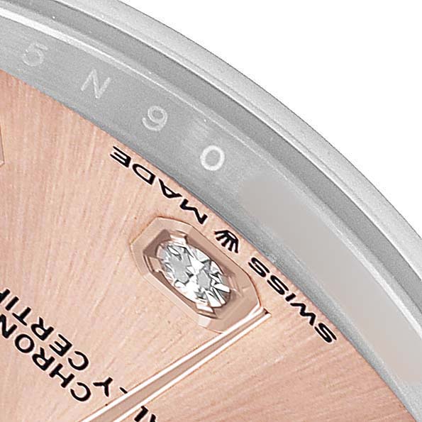 The image shows a close-up of the dial of a Rolex Datejust 278241 Women's Stainless Steel Pink Dial, highlighting a diamond marker and partial text.