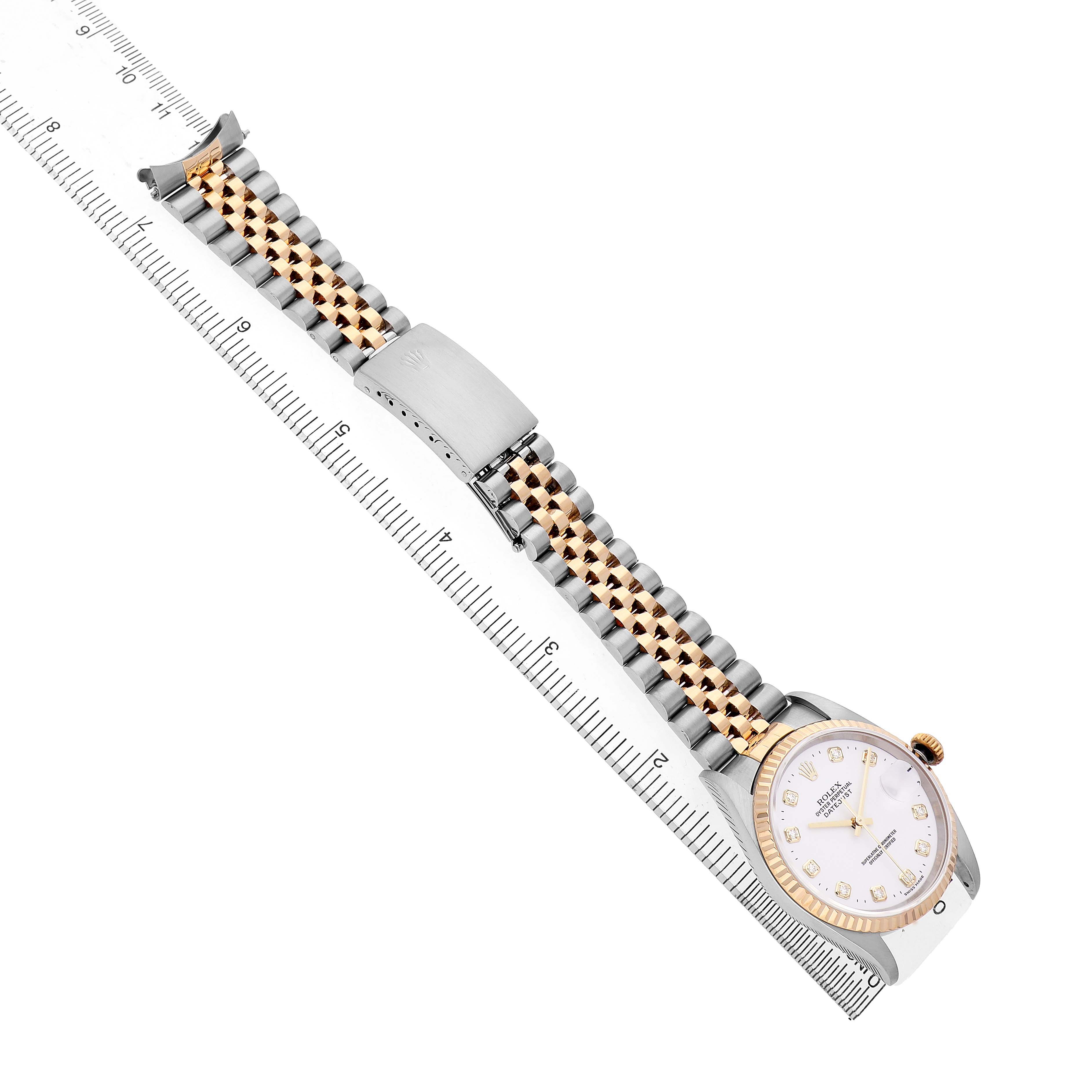 The image shows a Rolex Datejust 16233 Men's Steel and Gold (two tone) White Dial watch from a top-down angle, displaying the face, bezel, and Jubilee bracelet with a ruler alongside.