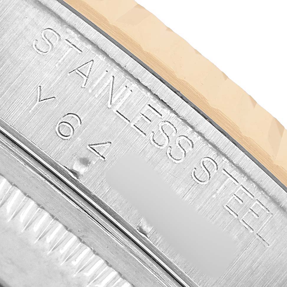 This close-up image shows the engraved side of a Rolex Datejust 16233 Men's Steel and Gold (two tone) White Dial stainless steel case.