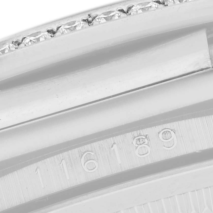 The image shows a close-up of the bezel and case edge of a Rolex Datejust 116189 Men
s White Gold Pink Dial 116189 Men
s White Gold Pink Dial watch, featuring a diamond-set bezel and partial model number.