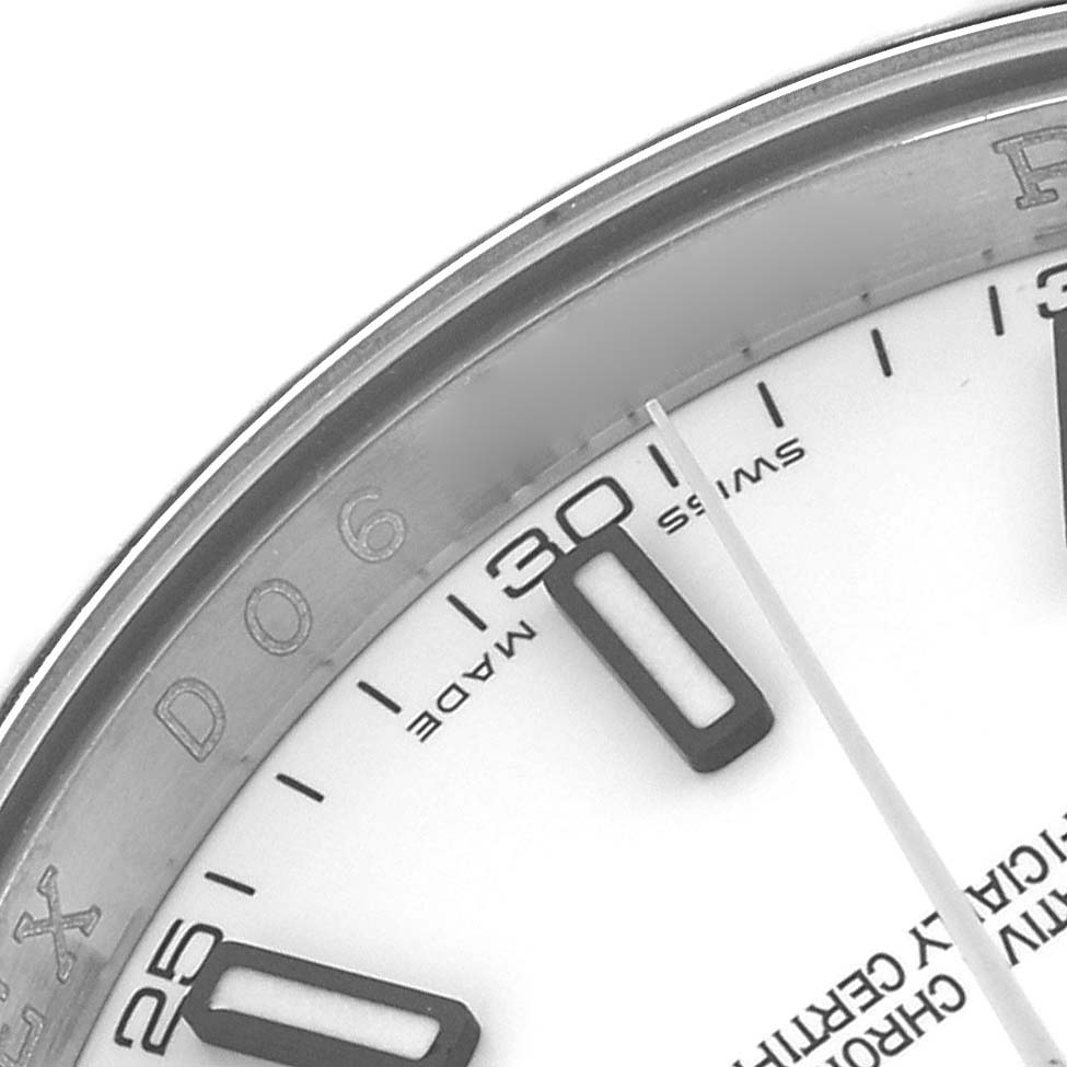 This close-up image shows the bezel and part of the dial with index markers of a Rolex Datejust 116139 Men's White Gold White Dial 116139 Men's White Gold White Dial watch.