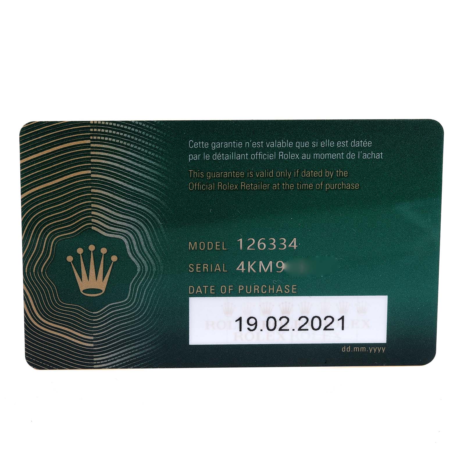 This image shows a close-up of a green warranty card for the Rolex Datejust 41 126334 Men's Stainless Steel Blue Dial 126334 Men's Stainless Steel Blue Dial model 126334.