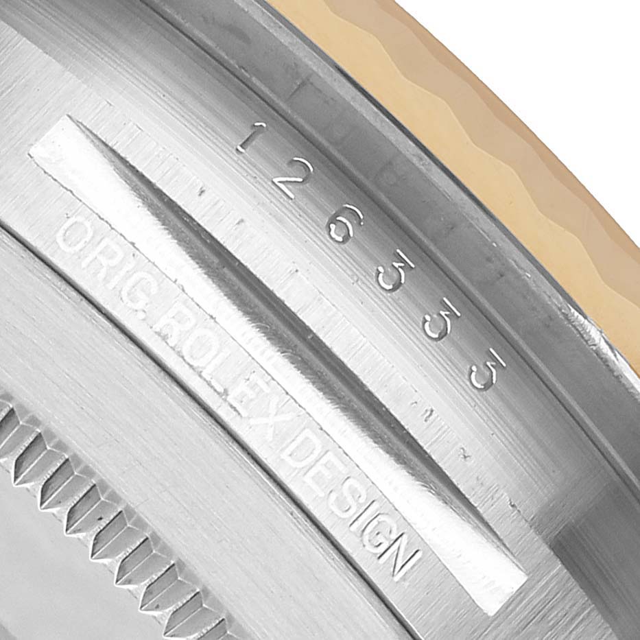 The image shows a close-up of the serial and model numbers inscribed on the side of a Rolex Datejust 126333 Men's Steel and Gold (two tone) Black Dial watch's case.