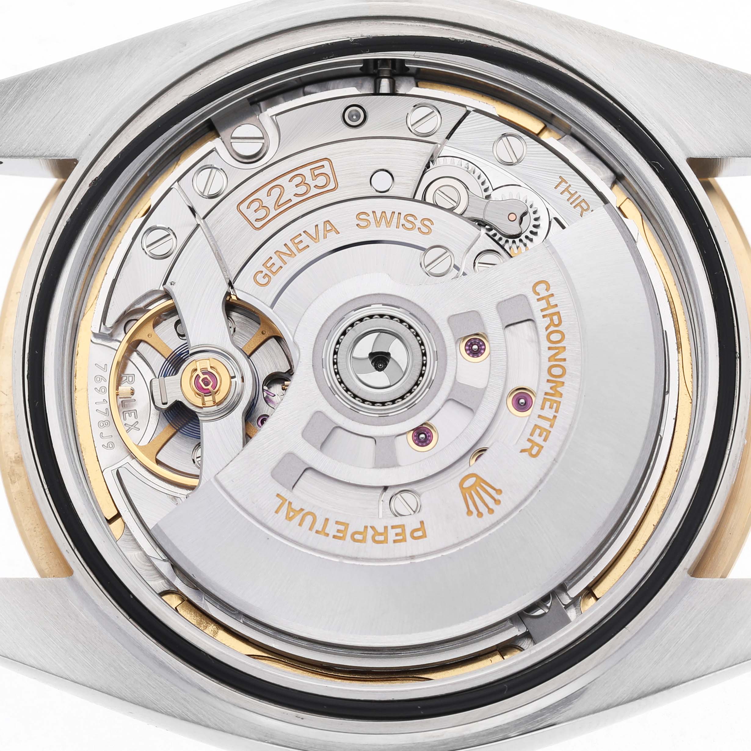 The image shows the movement mechanism of the Rolex Datejust 41 126333 Men's Steel and Gold (two tone) Grey Dial, highlighting the intricate parts and engravings.