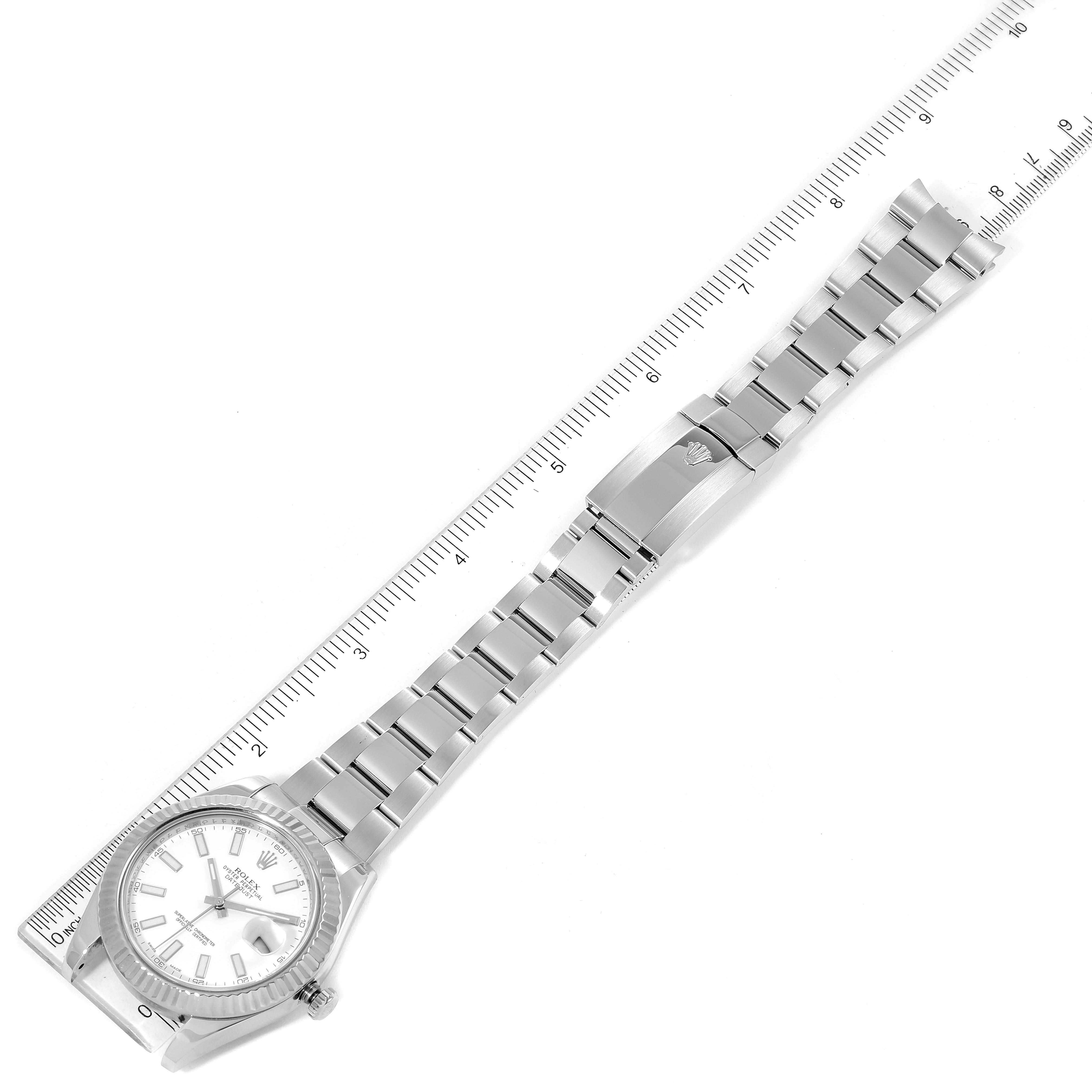 The image shows a top-down view of a Rolex Datejust 41 116334 Men's Stainless Steel White Dial 116334 Men's Stainless Steel White Dial watch with its full bracelet laid out beside a ruler.