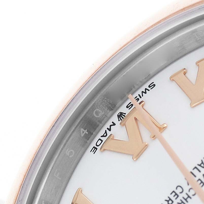 The image shows a close-up of the Datejust model by Rolex, highlighting the dial's Roman numeral markers and part of the bezel.