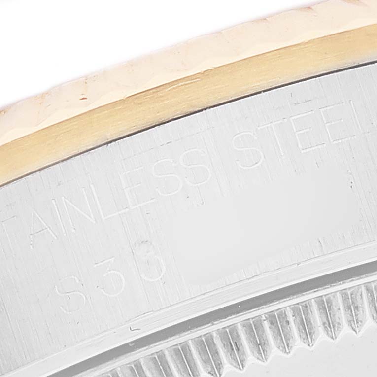Close-up of a Rolex Mid-Size 68273 Women's Steel and Gold (two tone) Champagne Dial 68273 Women's Steel and Gold (two tone) Champagne Dial watch's stainless steel section with engraving visible.