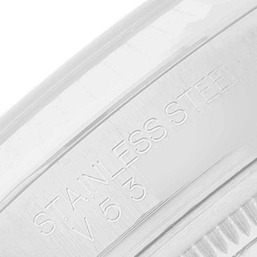 The image shows a close-up of the engraved side of the Rolex Datejust 116234 Men's Stainless Steel Blue Dial 116234 Men's Stainless Steel Blue Dial model, highlighting the "STAINLESS STEEL" marking.