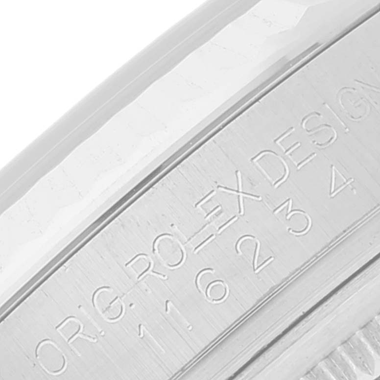 The image shows a close-up of the engraved serial number on the case side of a Rolex Datejust 116234 Men's Stainless Steel Blue Dial 116234 Men's Stainless Steel Blue Dial watch.