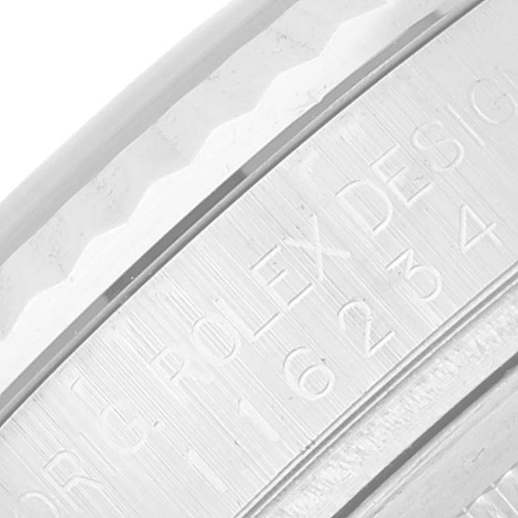 The image shows a close-up of the engraved bezel of a Rolex Datejust 116234 Men's Stainless Steel Black Dial 116234 Men's Stainless Steel Black Dial watch.