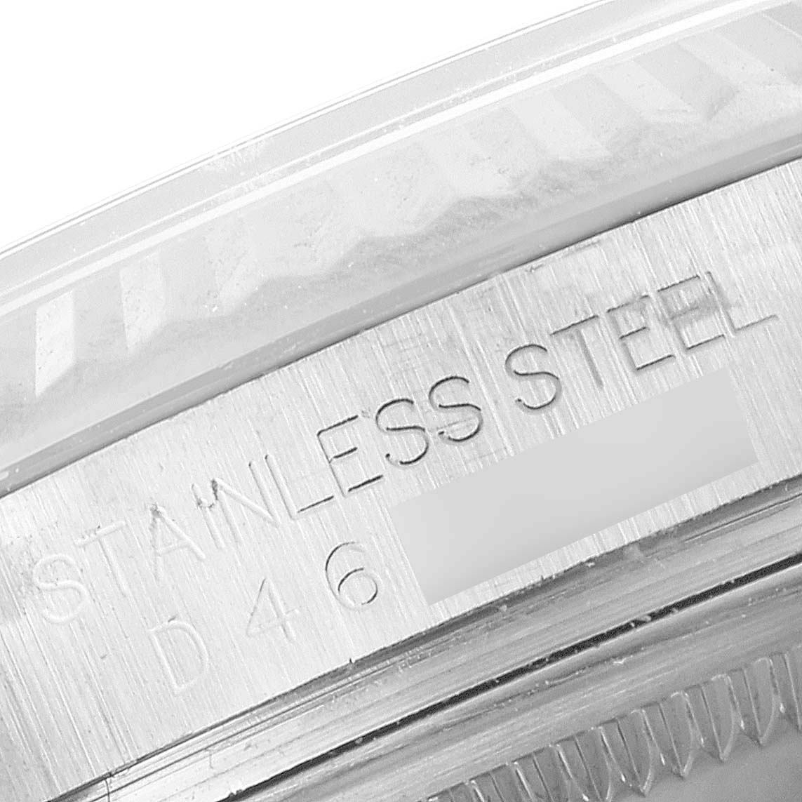This close-up image shows the side engraving on the bezel of a Rolex Datejust 116234 Men's Stainless Steel Blue Dial 116234 Men's Stainless Steel Blue Dial watch, indicating it's made of stainless steel.