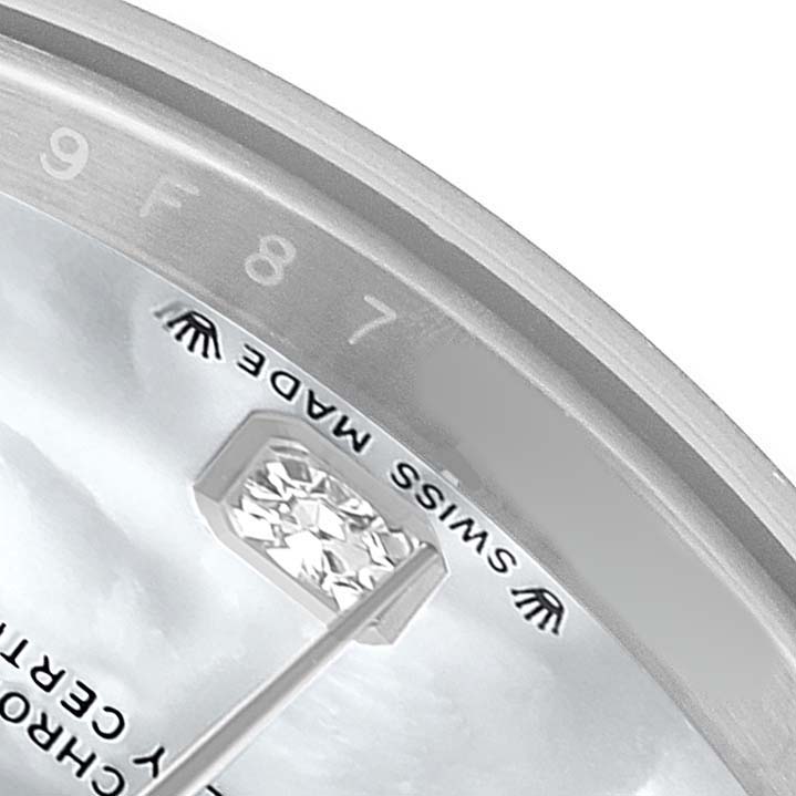The close-up shows the Rolex Datejust 279174 Women's Stainless Steel Mother of Pearl Dial watch face, including the "SWISS MADE" label, part of the hour hand, and a diamond marker.