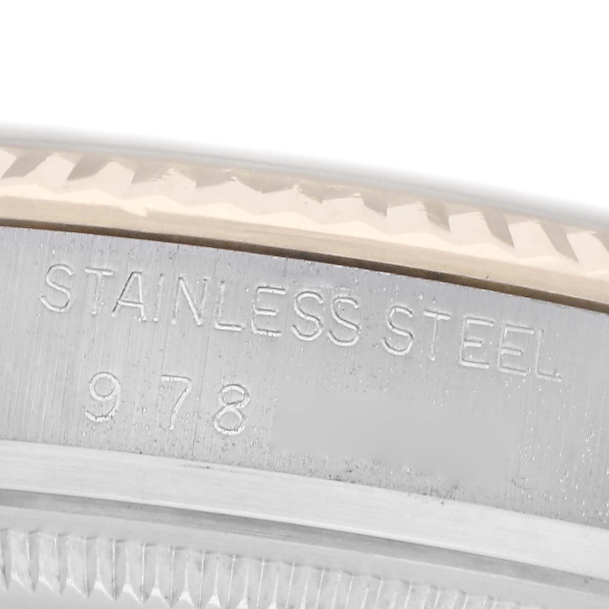 The image shows a close-up of the side of a Rolex Vintage Collection 16013 Men
s Steel and Gold (two tone) Black Dial 16013 Men
s Steel and Gold (two tone) Black Dial watch with "STAINLESS STEEL" and numbers engraved.