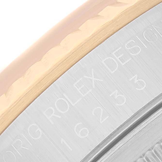 This image shows a close-up of the bezel and engraved case side of a Rolex Datejust 16233 Men's Steel and Gold (two tone) Champagne Dial 16233 Men's Steel and Gold (two tone) Champagne Dial watch, displaying the model and design information.