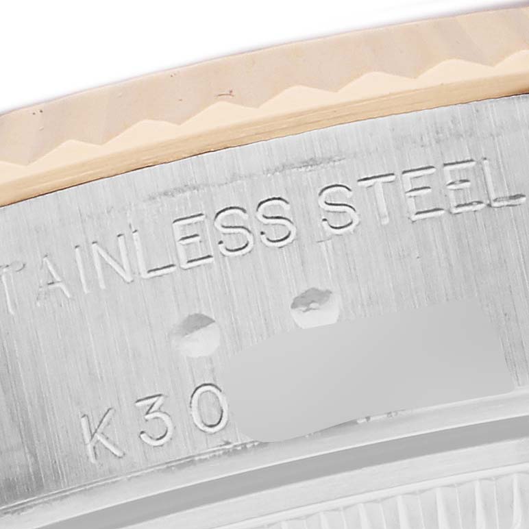 The image shows a close-up of the Rolex Datejust 79173 Women
s Steel and Gold (two tone) Black Dial 79173 Women
s Steel and Gold (two tone) Black Dial case, highlighting the stainless steel engraving and part of the bezel.